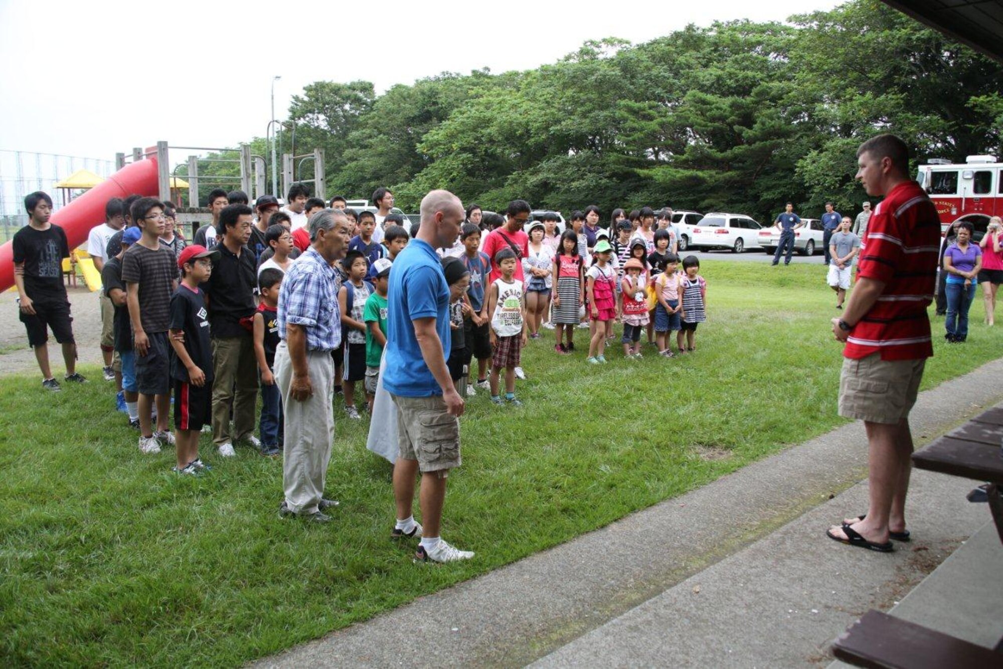 Maj. Paul Miller, 35th Logistics Readiness commander, addresses visitors from Fuji Seiboen Orphanage at Leftwich Park in Aomori, Japan on Aug. 18, 2012. The 35 LRS has been volunteering at the orphanage for 45 years. (Courtsey photo/Released)