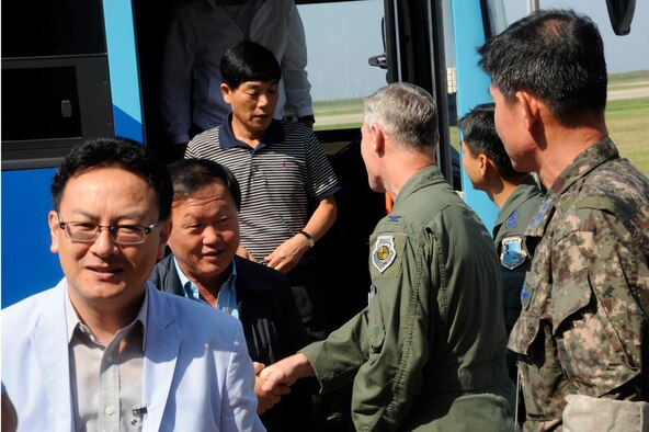 U.S. Air Force Col. John Pearse, 8th Fighter Wing commander, and Republic of Korea Air Force Col. Eun-Sung Baek, 38th Fighter Group commander, welcome 17 members of South Korean media at Kunsan Air Base, Republic of Korea, Sept. 7, 2012. The tour allowed the South Korean media to see how USAF and ROKAF work together to accomplish their mission. (U.S. Air Force photo/Senior Airman Marcus Morris)