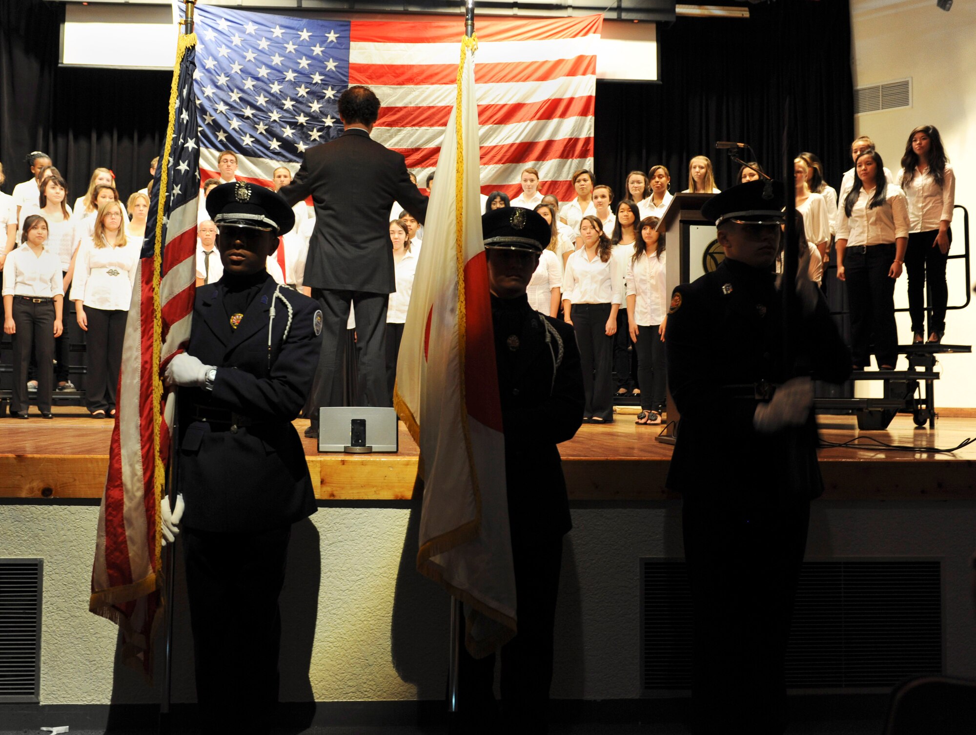 Kadena's Junior ROTC present the colors during Patriot Day at the high school while the choir sings the National Anthem on Kadena Air Base, Japan, Sept. 12, 2012. The high school has paid tribute to the victims of 9/11 for 11 years. (U.S. Air Force photo/Airman 1st Class Malia Jenkins)   