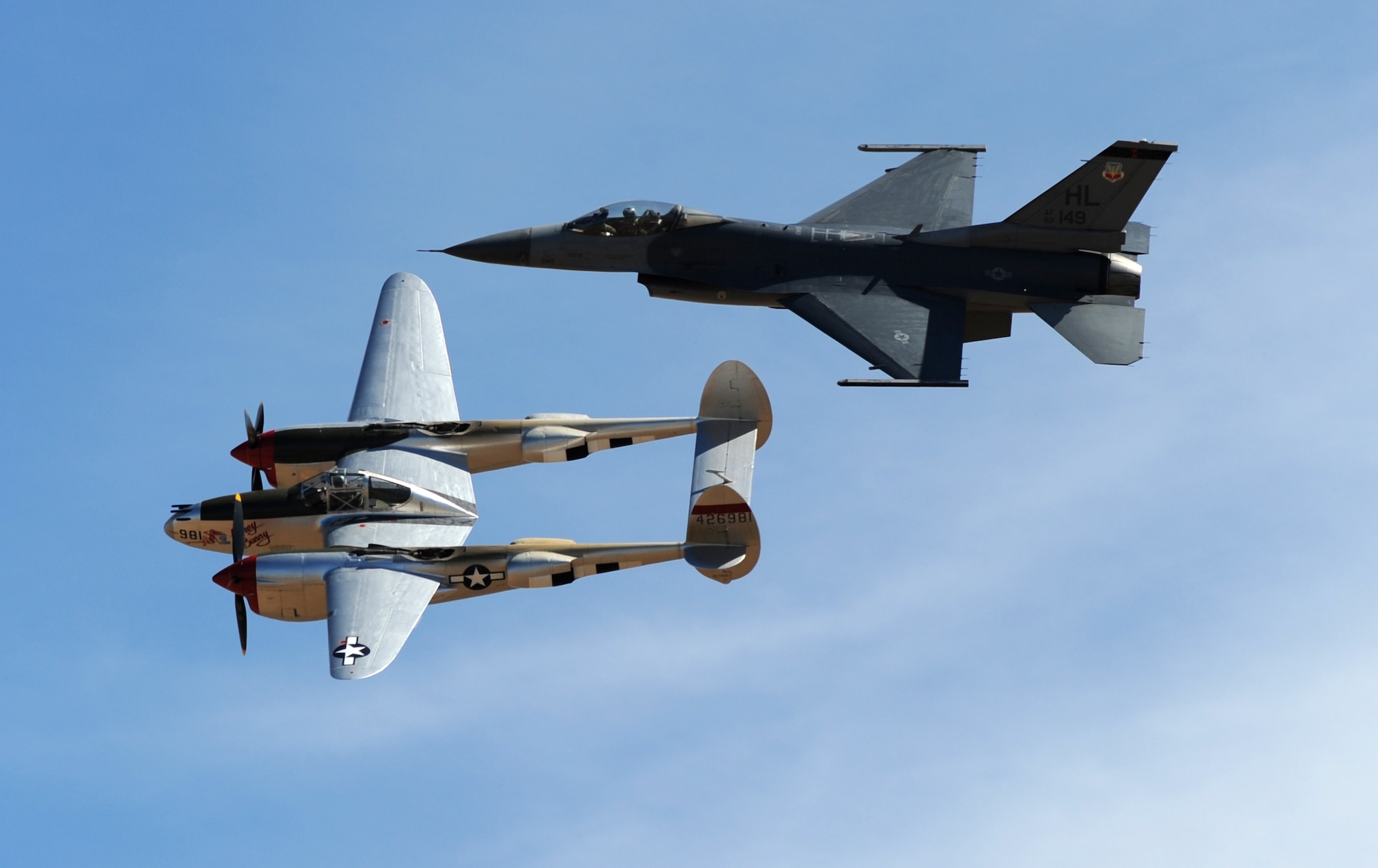 A vintage P-38 Lighting and an Air Force F-16 Fighting Falcon fighter aircraft perform a heritage flight during the Capital City Air Show at Mather Airport, Sacramento, Calif., Sept. 8, 2012. The Heritage Flight program represents the evolution of Air Force airpower by flying today's state-of-the-art fighter aircraft in close formation with a historic fighter aircraft. (U.S. Air Force photo by Staff Sgt. Robert M. Trujillo)