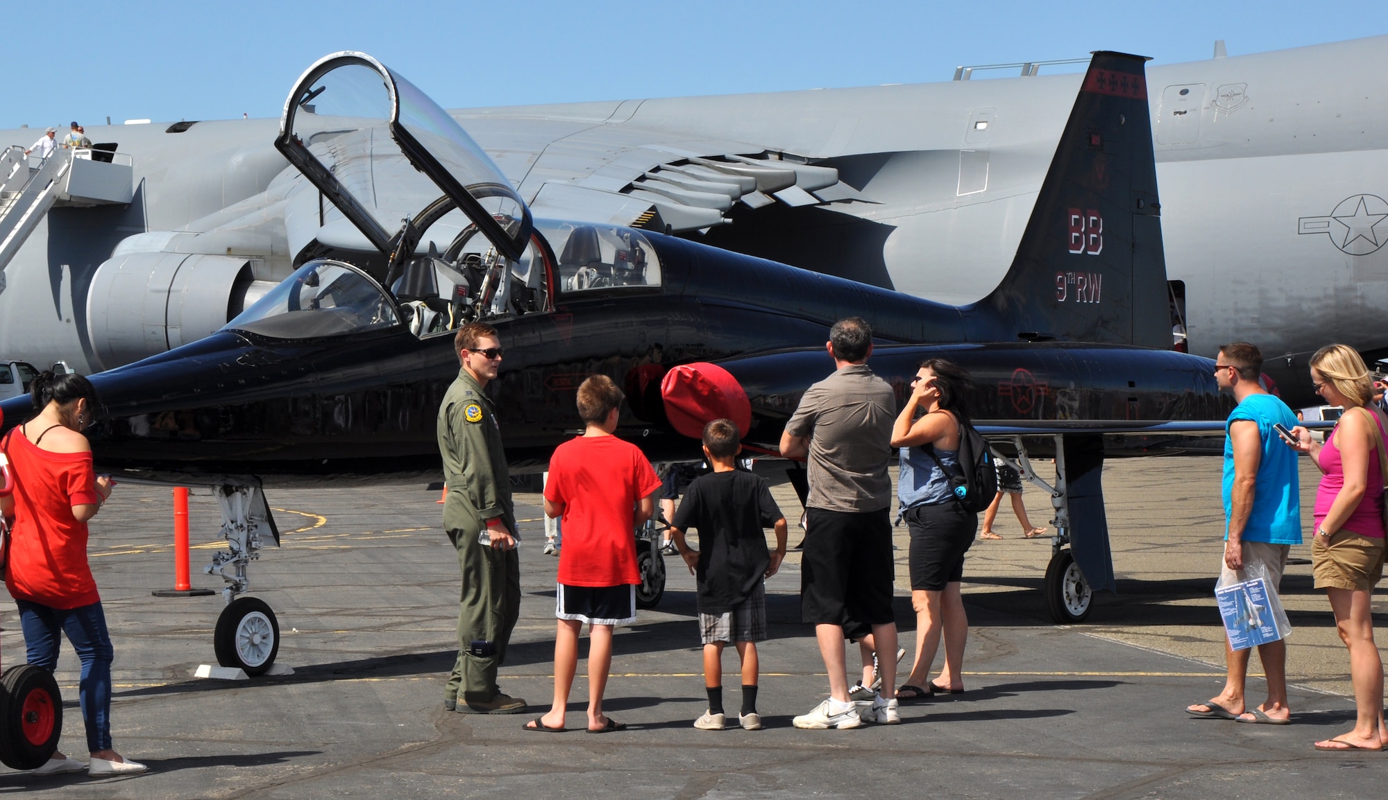 A pilot from Beale Air Force Base answers questions about the Air Force T-38 Talon trainer aircraft static display at the Capital City Air Show at Mather Airport, Sacramento, Calif., Sept. 8, 2012. The Talon is primarily used by Air Education and Training Command for joint specialized undergraduate pilot training. (U.S. Air Force photo by Staff Sgt. Robert M. Trujillo)