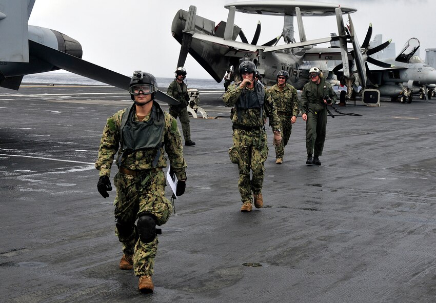 PACIFIC OCEAN (Sept. 12, 2012) Navy Diver 1st Class Ryan
Conley (left) and other members of Explosive Ordinance Disposal Mobile Unit
5, Platoon 503 return to USS George Washington (CVN 73) after making final
preparations aboard the ex-USS Coronodo for sinking the ship as part of
Valiant Shield 2012. A live-fire event during VS12 later sank the
ex-Coronado providing an opportunity for active duty forces to gain
proficiency in tactics, targeting and live firing practice against a surface
target and enhancing combat readiness of deployed units. Strict
environmental compliance is observed during all SINKEXs. Each SINKEX is
required to sink the hulk in at least 1,000 fathoms (6,000 feet) and at
least 50 nautical miles from land. Surveys are conducted to ensure that
humans and marine mammals are not in an area where they could be harmed
during the event. (U.S. Navy photo by Mass Communication Specialist Seaman
Apprentice Brian H. Abel/RELEASED)
