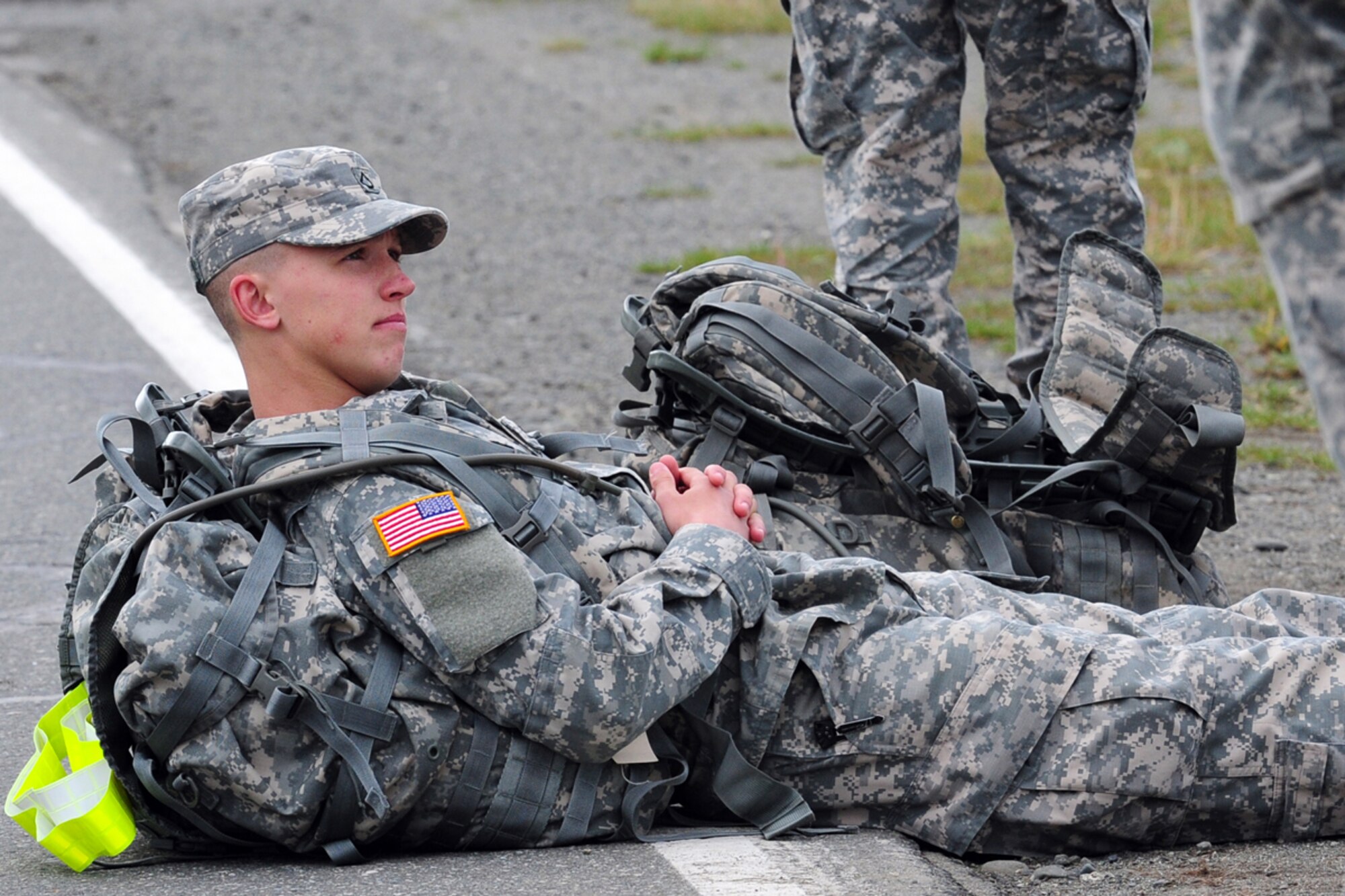 JOINT BASE ELMENDORF-RICHARDSON, Alaska -- Private 1st Class William Stamey, 1st Squadron (Airborne) 40th Cavalry Regiment, of Canton, N.C., rests before running in a Combat Cross-Country Series, 10-Mile Relay on the Davis Highway, Friday, Sept. 7, 2012.  The relay consisted of five five-man teams in Army Combat Uniforms and combat boots racing for the best time with 35 lbs. rucksacks.  (U.S. Air Force photo by Justin Connaher)