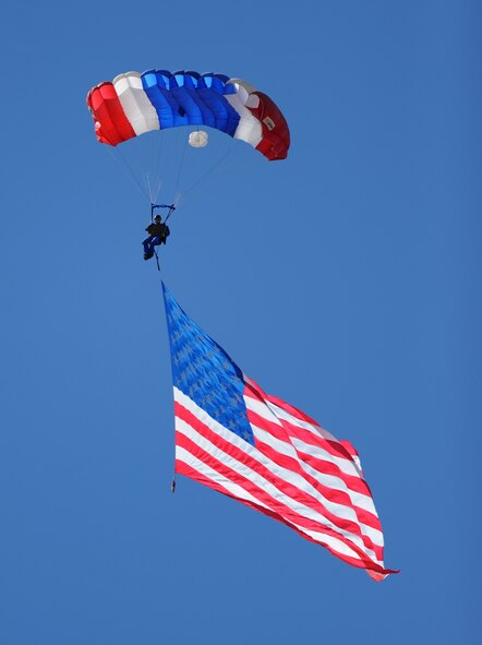 Parachutist Kent Lane carries the Stars and Stripes during the opening ceremonies of the Capital City Air Show at Mather Airport, Sacramento, Calif., Sept. 8, 2012. Lane started skydiving in1976 and has more than 800 jumps in competition and exhibition. (U.S. Air Force photo by Airman 1st Class Andrew Buchanan/Released) 

