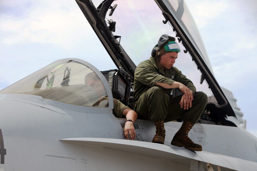 ANDERSEN AIR FORCE BASE, Guam – U.S. Marine Corps Lance Cpl. Kevin R. Smith, a fixed-wing aircraft airframe mechanic, awaits instruction from air crew on the ground during a pre-flight check aboard an F/A-18D Hornet from Marine Fighter Attack Squadron 225 (VMFA(AW)) prior to take-off from Andersen Air Force Base, Guam, Sept. 12, in support of Valiant Shield 2012. Valiant Shield is an ongoing biennial joint-service exercise; this is the fourth iteration of the exercise series. The exercise lasts from Sept. 11 - 19, 2012.  (U.S. Marine photo by Lance Cpl. Brianna Turner/ Released)
