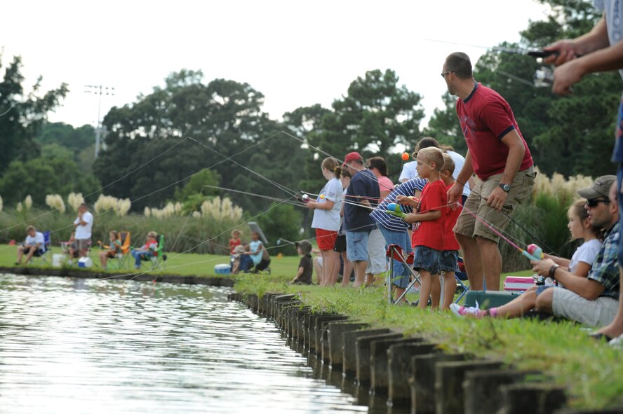 Team Seymour families participate in the Catch & Release Fishing Derby on Seymour Johnson Air Force Base, N.C., Sept. 9, 2012. Members of the 4th Force Support Squadron hosted the free derby for children ages 3 to 18 and provided the competitors live bait and bobbers. (U.S. Air Force photo/Airman 1st Class Aubrey Robinson/Released)