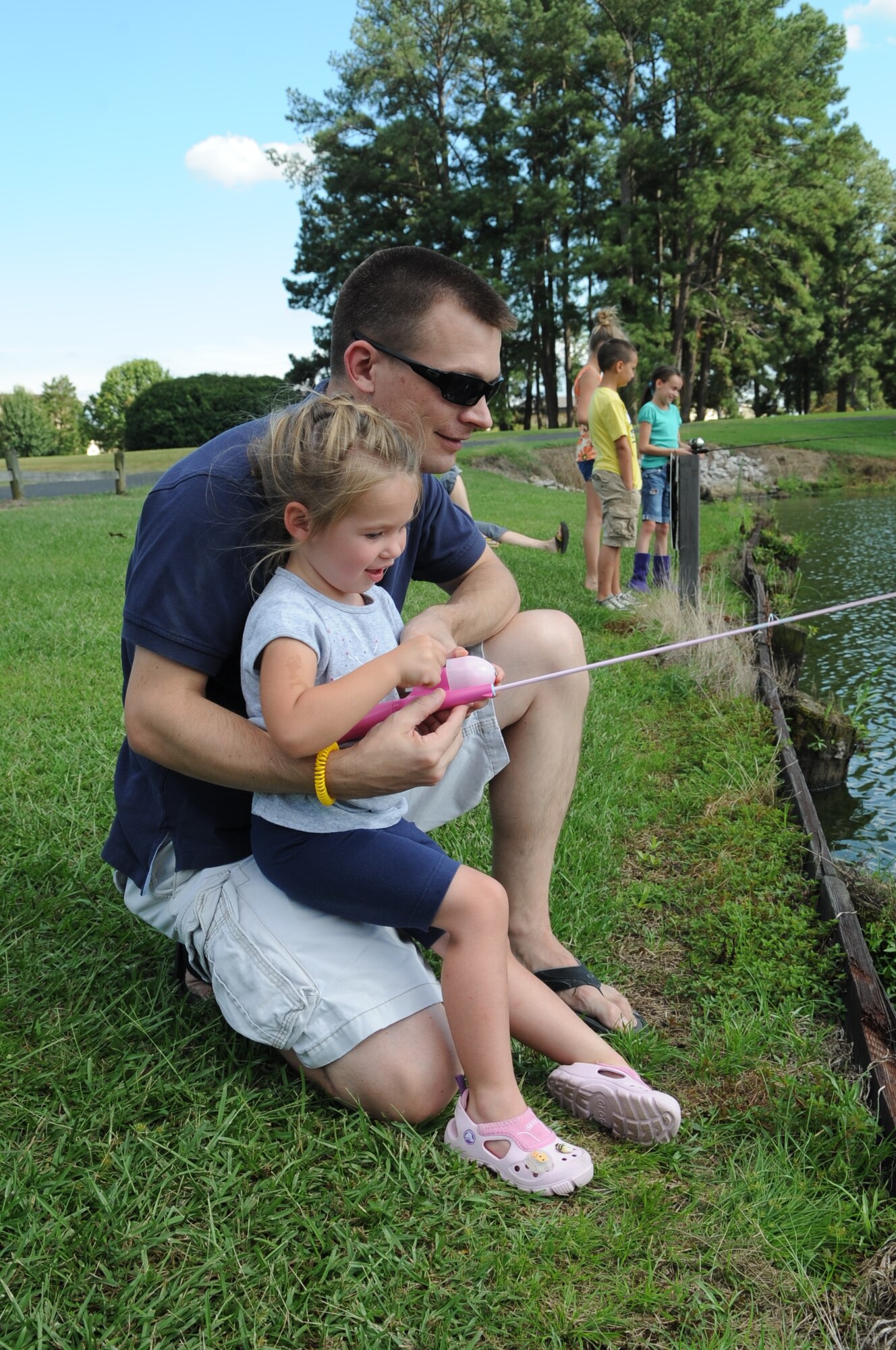 U.S. Air Force Maj. Joshua Droz, 4th Fighter Wing chief of command post, and his daughter Kara Droz, 3, fish during the Catch & Release Fishing Derby on Seymour Johnson Air Force Base, N.C., Sept. 9, 2012. Many parents used this opportunity to teach their children how to fish. (U.S. Air Force photo/Airman 1st Class Aubrey Robinson/Released)