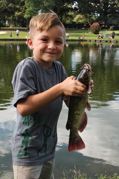 T.J. Ruffino, 8, shows off a catfish he caught during the Catch & Release Fishing Derby on Seymour Johnson Air Force Base, N.C., Sept. 9, 2012. T.J. caught the largest fish of the evening, weighing in at 1.8 ounces. T.J. is the son of U.S. Air Force Master Sgt. Daniel Ruffino, assistant NCO in charge of Wing Plans. (U.S. Air Force photo/Airman 1st Class Aubrey Robinson/Released)