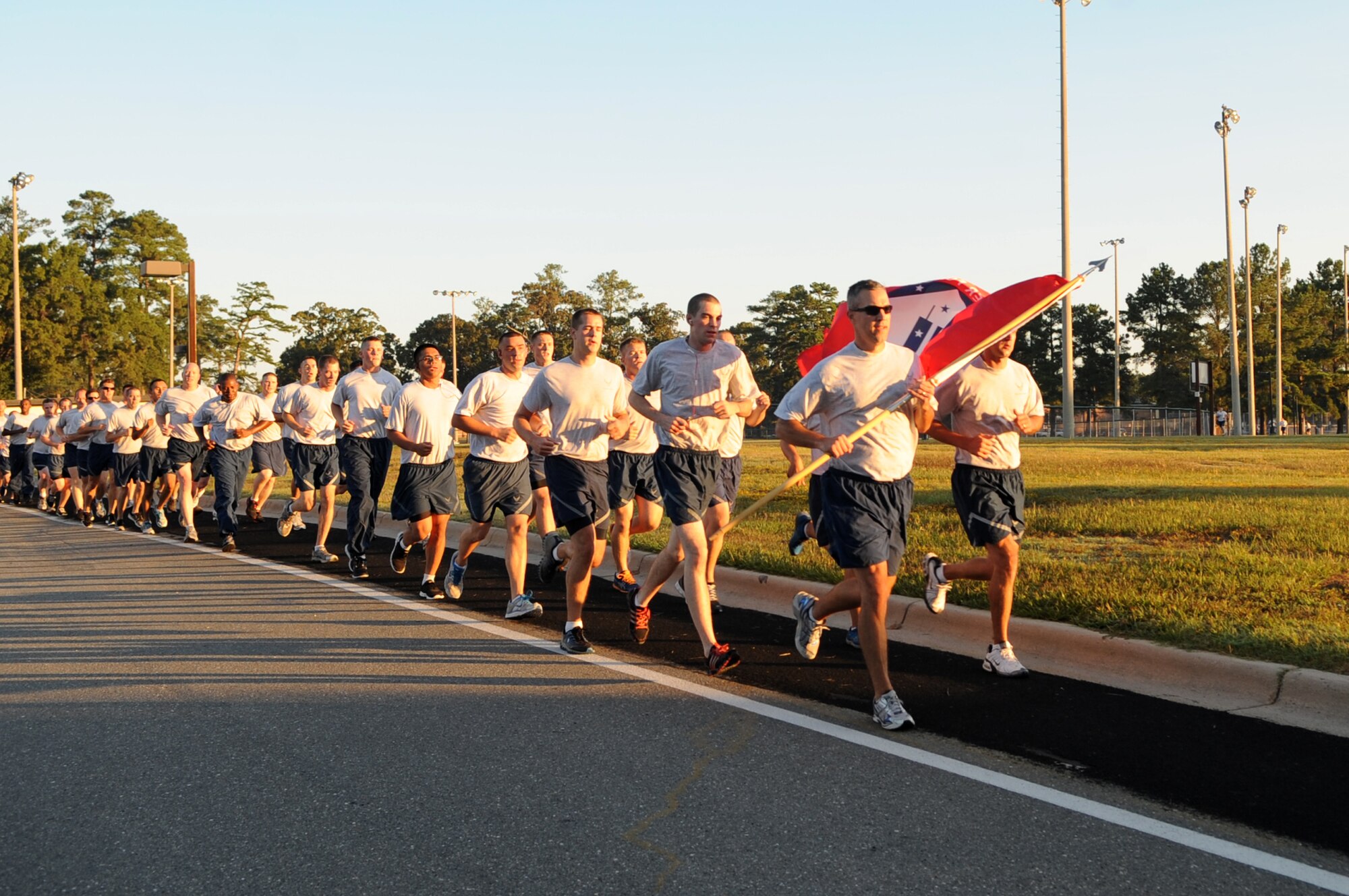 U.S. Air Force Lt. Col. Richard Dwyer, 4th Civil Engineer Squadron commander, carries the 9/11 Remembrance Flag as he leads members of his unit during a remembrance run on Seymour Johnson Air Force Base, N.C., Sept. 12, 2012. The 24-hour run, hosted by 4th CES firefighters, was one of many events held on base to commemorate the anniversary of 9/11. (U.S. Air Force photo/Airman 1st Class Aubrey Robinson/Released)