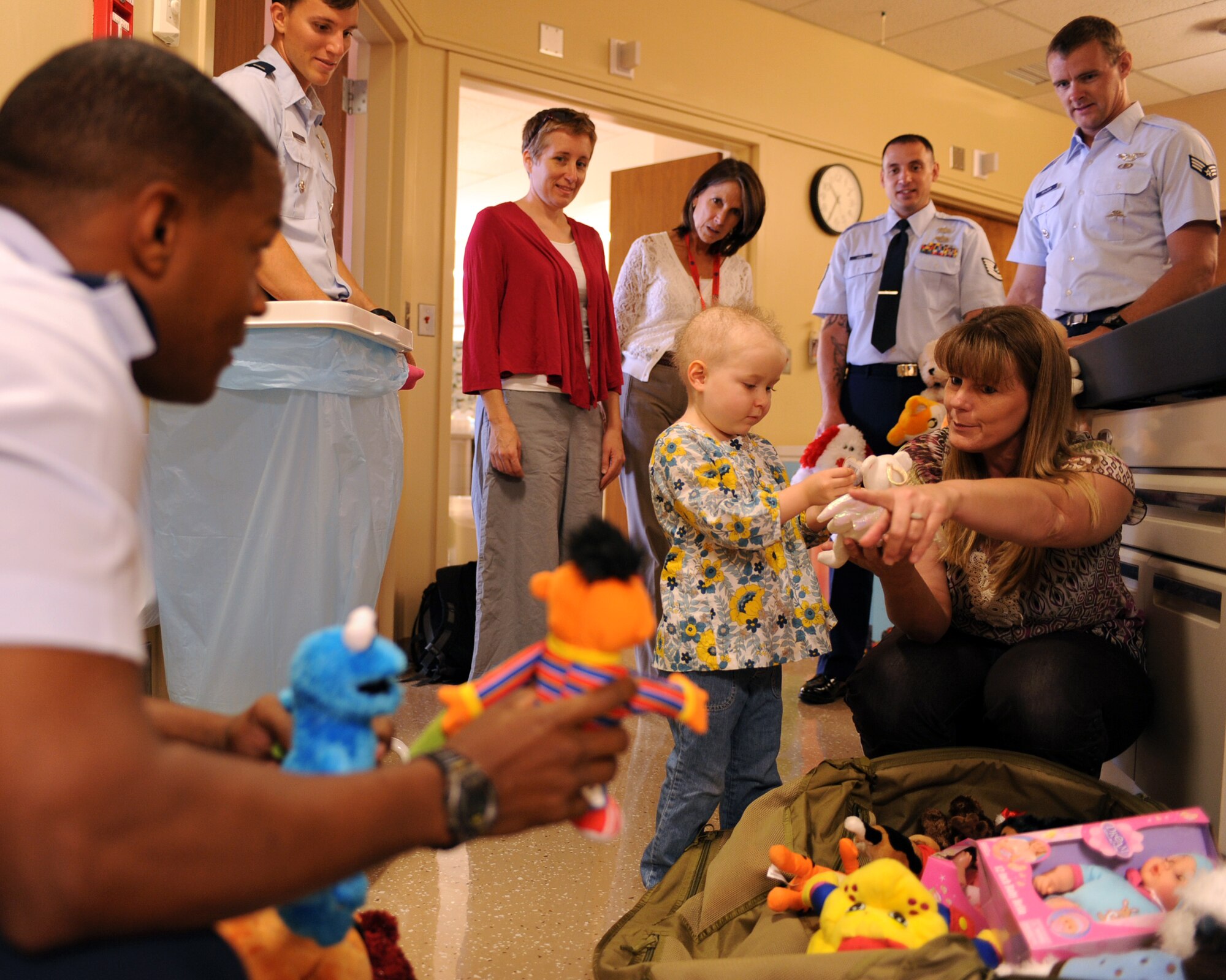 U.S. Air Force Airmen from the 48th Rescue Squadron hand out stuffed animals to children at the University Medical Center in Tucson, Ariz., Sept. 10, 2012. The stuffed animals were handed out in honor of Janie Fahrendorff, who had passed away of cancer and had asked for the stuffed animals to be given to the children. (U.S. Air Force photo by Airman 1st Class Christine Griffiths/Released)