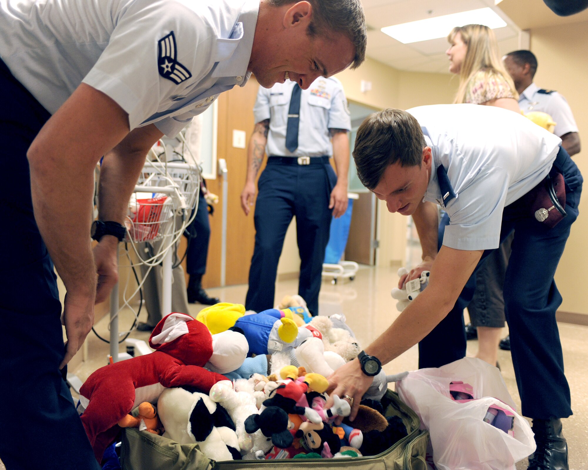 U.S. Air Force Senior Airman Jordan Dehlbom and 1st Lt Phillip Cole, 48th Rescue Squadron, look for specific stuffed animals for each child at the University Medical Center in Tucson, Ariz., Sept. 10, 2012. (U.S. Air Force photo by Airman 1st Class Christine Griffiths/Released) 

