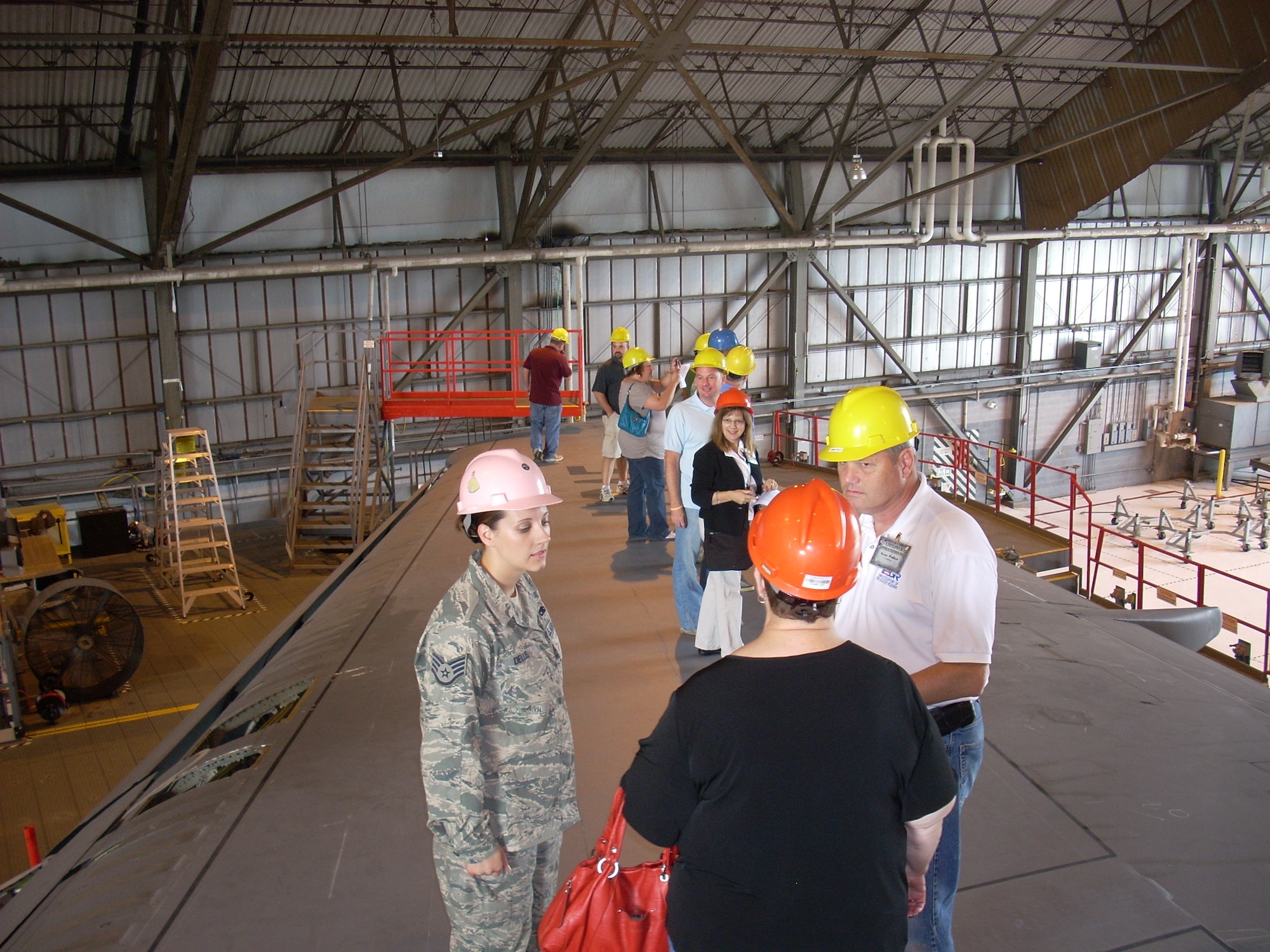 While standing on the wing of a C-5 Galaxy, Air Force Reserve Staff Sgt. Jennifer L. Dellis of the 512th Maintenance Squadron, Dover Air Force Base, Del., explains the isochronal inspection process Sept. 8, 2012, to Joan A. Causey and and Gene Pulket during the 512th Airlift Wing's annual Employer Appreciation Day. Causey is the deputy assistant secretary for financial operations at the Office of the Assistant Secretary for Financial Management and Comptroller at the Pentagon. Pulket is with Delaware's Employer Support of the Guard and Reserve program. (U.S. Air Force photo by Chief Master Sgt. Matt Proietti)