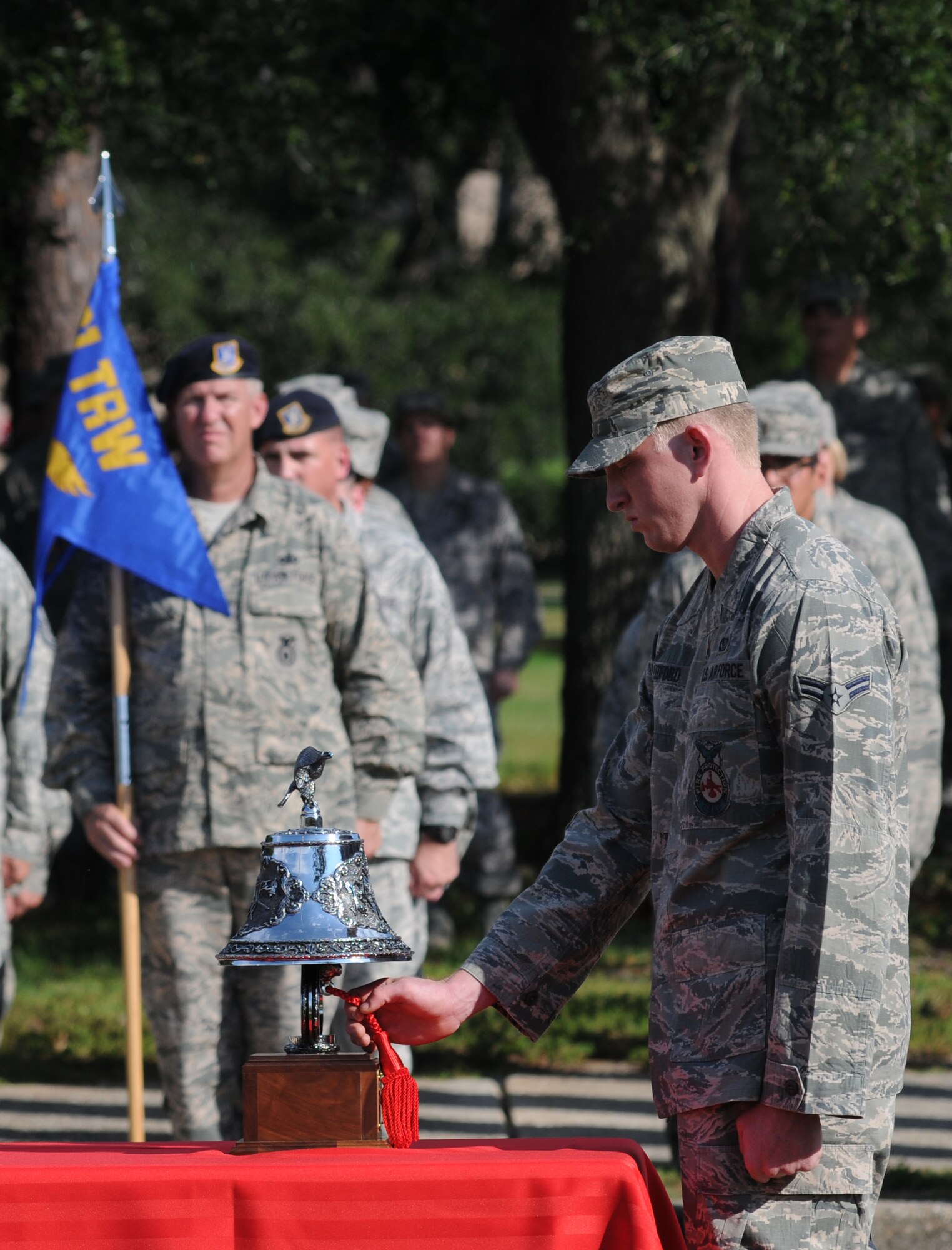 Airman 1st Class Kyle Ledford, Keesler firefighter, signals five short rings of the fire department dispatch bell to signify the last alarm for all emergency responders who perished on Sept 11, 2001 while performing their duties responding to citizens in need. The retreat ceremony took place in front of wing headquarters at Keesler Air Force Base, Miss., Sept. 11, 2012.  (U.S. Air Force photo by Kemberly Groue)
