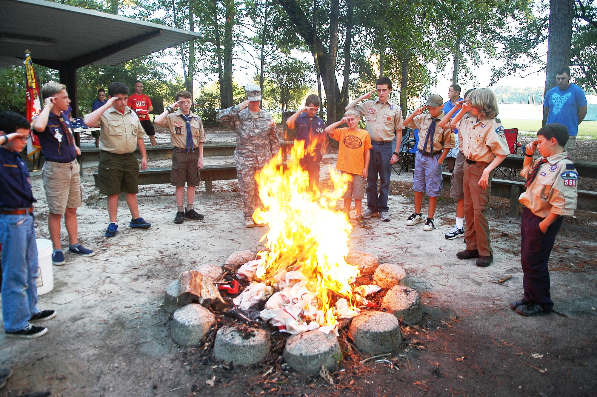 Scouts from Troop and Pack 220 located on Robins AFB honored the remembrance of the eleventh anniversary of 9/11 with a solemn flag retirement ceremony at the Fire Ring near the Pave Paws facility. (U. S. Air Force photo/Sue Sapp)