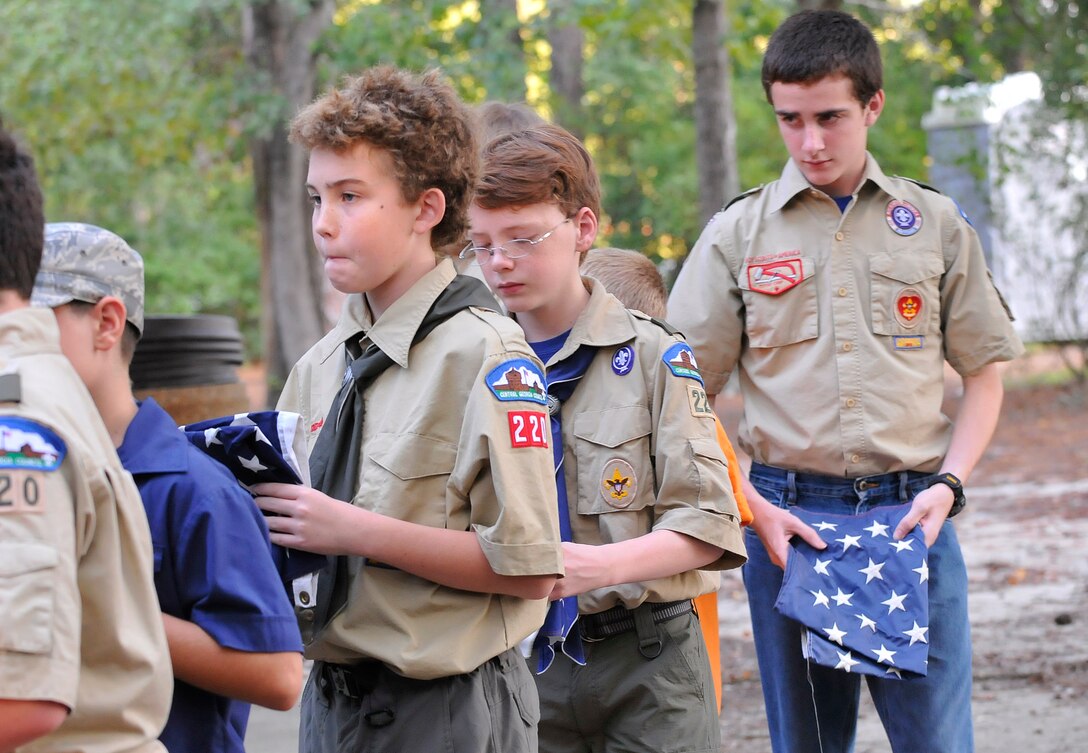 Scouts carry a blue star field from the retiring flags to the fire. Scouts from Troop and Pack 220 located on Robins AFB honored the remembrance of the eleventh anniversary of 9/11 with a solemn flag retirement ceremony at the Fire Ring near the Pave Paws facility.The traditional method of retirement is to incinerate the flag, but this does not mean that one should simply drop the entire flag (intact) into a fire. A flag ceases to be a flag when it is cut into pieces. In addition, it is easier to completely incinerate the flag, if it is cut into smaller pieces. Stripes may be cut separate and incinerated by color, to explain the meaning of each color. The blue star field is left intact as it represents the union of the fifty states and one should never let the union be broken. The Scouts maintain a vigil over the fire until all traces of the flag remnants are destroyed. Then, the fire is extinguished and the ashes are buried.  (U. S. Air Force photo/Sue Sapp)