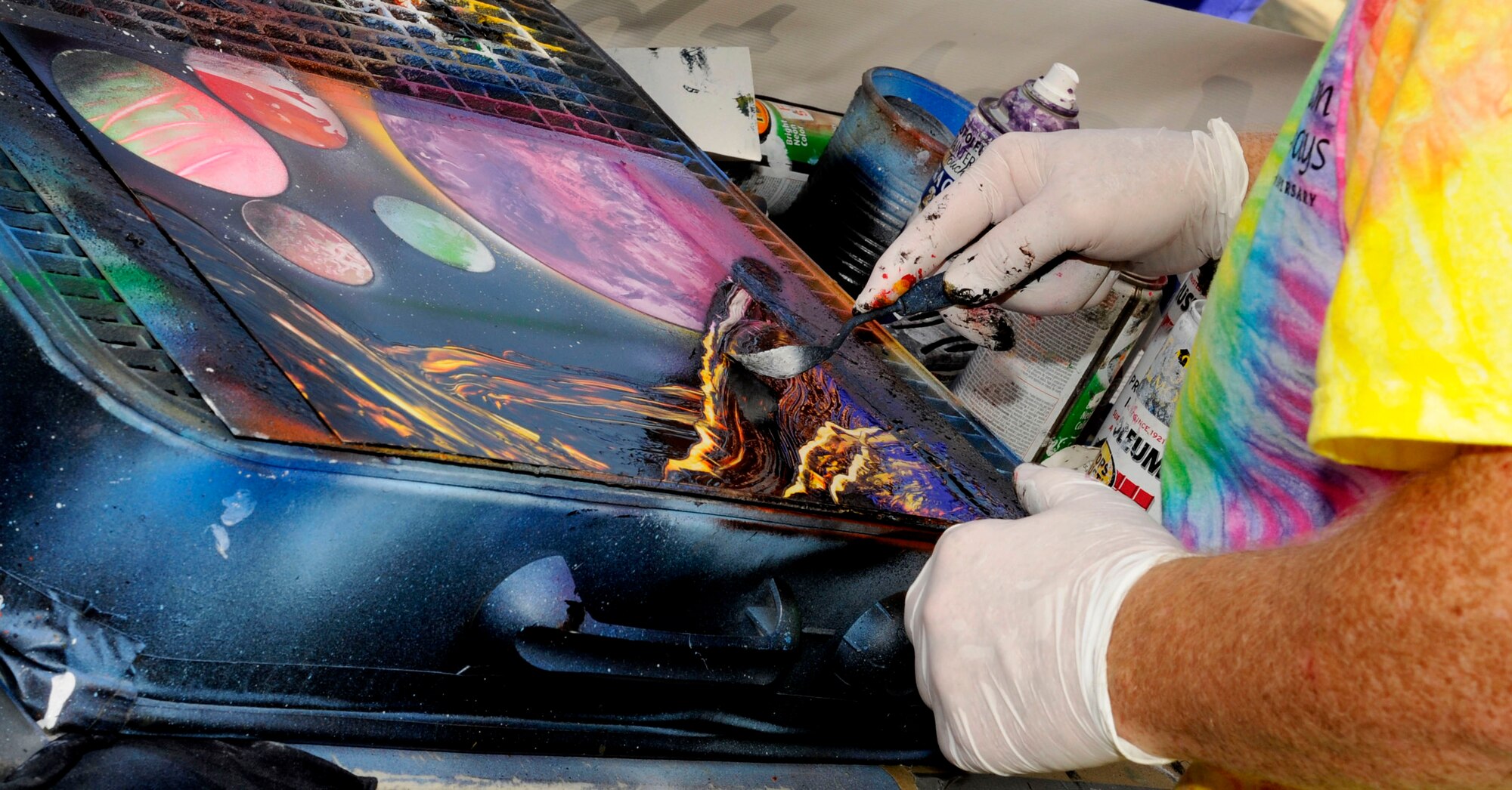Bryan Lopatic, a U.S. Air Force supervisory illustrator and Air Combat Command Multimedia Center section chief, creates artwork for visitors at the 30th Annual Hampton Bay Days festival in Hampton, Va., Sept. 8, 2012. Lopatic, the festival’s annual poster contest winner, uses spray-paint as the primary medium in a style called aerosolgrafia. (U.S. Air Force photo by Staff Sgt. Krystie Martinez/Released)