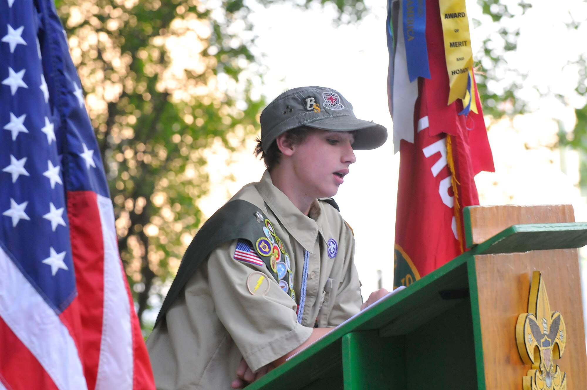 Garrett Cox recounts the events of 9-11 and asks for a moment of silence in remembrance of that day. Scouts from Troop and Pack 220 located on Robins AFB honored the remembrance of the eleventh anniversary of 9/11 with a solemn flag retirement ceremony at the Fire Ring near the Pave Paws facility. (U. S. Air Force photo/Sue Sapp)