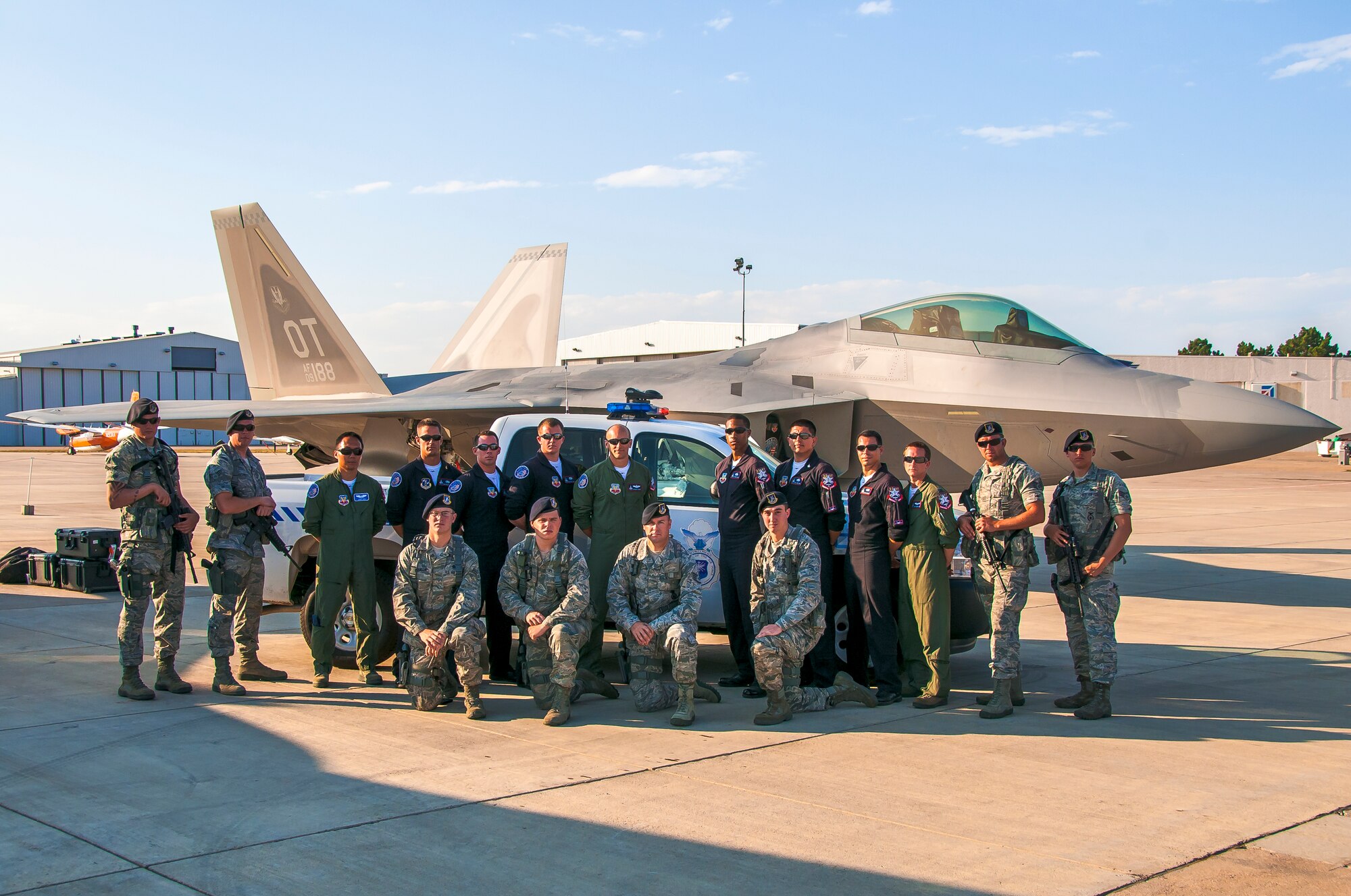 BROOMFIELD, Colo. -- Members of the 460th Security Forces Squadron pose with the F-22 Raptor Demonstration Team from Holloman Air Force Base, N.M., during the Rocky Mountain Airshow held the last weekend in August at the Rocky Mountain Metropolitan Airport. Eight 460th SFS Airmen were selected to provide around-the-clock security for the F-22 aircraft Aug. 23-27. (Photo by Scott E. Wolff) 