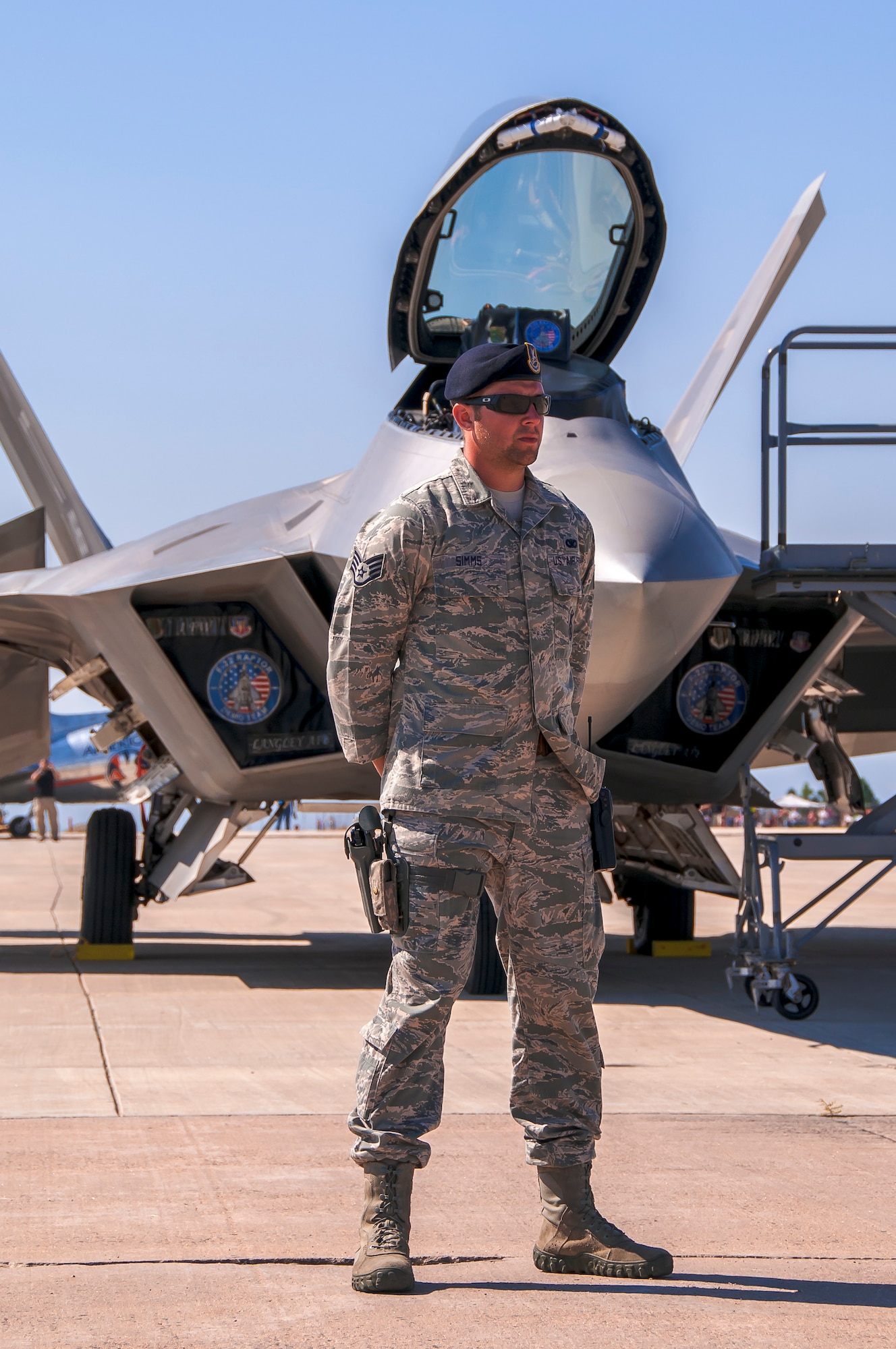 BROOMFIELD, Colo. – Staff Sgt. Trevor Simms, 460th Security Forces Squadron, provides security for an F-22 Raptor from Holloman Air Force Base, N.M., during the Rocky Mountain Airshow at the Rocky Mountain Metropolitan Airport. Eight Airmen provided 24-hour security for the F-22 aircraft, which were a highlight of the airshow held the last weekend in August. (Photo by Scott E. Wolff) 