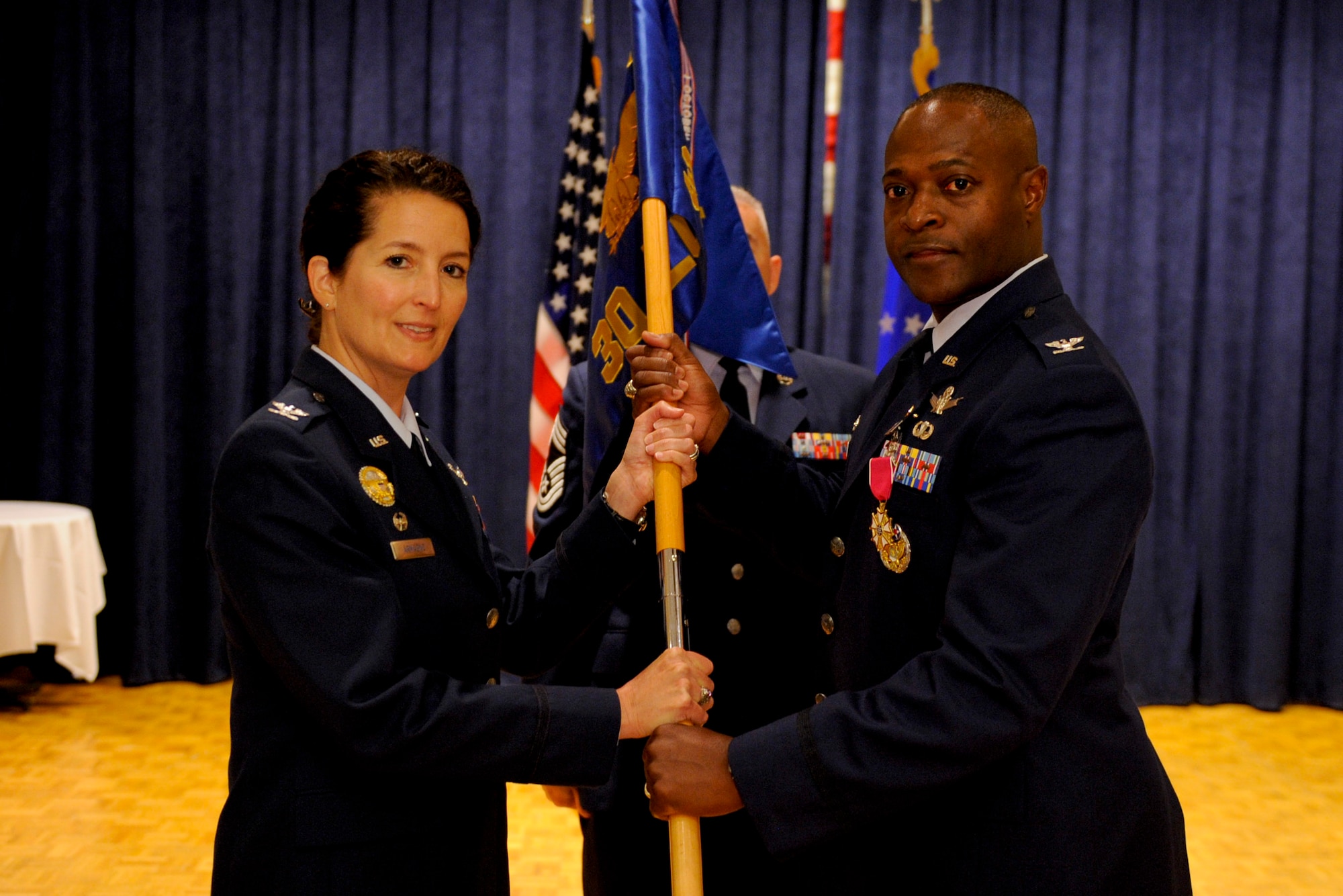 VANDENBERG AIR FORCE BASE, Calif. -- Col. Lavanson Coffey III, 30th Launch Group outgoing commander, relinquishes command of the 30th LCG to Col. Nina Armagno, 30th Space Wing commander, during the 30th Launch Group change of command at the Pacific Coast Club here Monday, September 10, 2012.  Col. Shahnaz Punjani took command of the group after Col. Lavanson Coffey III relinquished command. (U.S. Air Force photo/Staff Sgt. Levi Riendeau)
