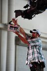 Camera assistant Will Hand for the Lifetime drama series Army Wives, says action while holding a clap board, at Nose Dock 1, June 20, 2012, at Joint Base Charleston - Air Base, S.C. Army Wives tells the story of four women and one man who are brought together by their common bond – they all have military spouses. The series is based on the book "Under the Sabers: The Unwritten Code of Army Wives" by Tanya Biank. Army Wives is produced by ABC Television Studio and The Mark Gordon Company.  (U.S. Air Force photo/ Airman 1st Class Chacarra Walker)