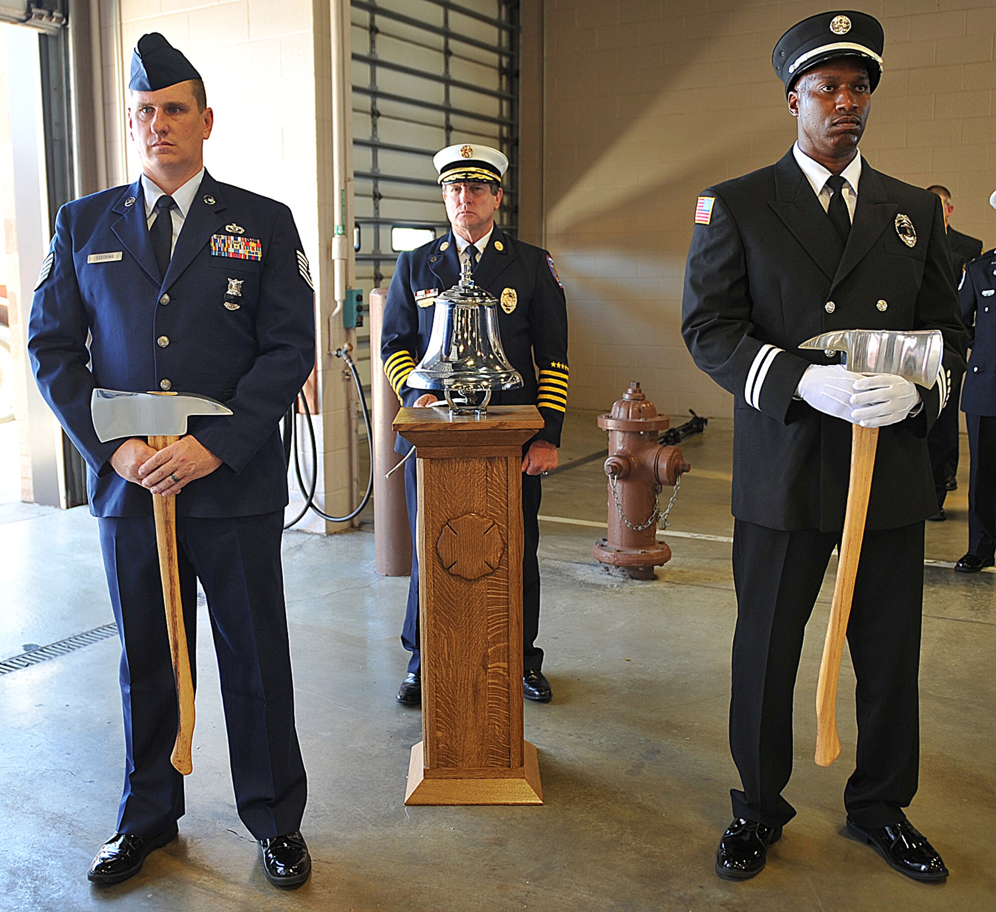 Gary Curmode, Sedgwick County fire chief, rings the bell during a Patriot Day Retreat Ceremony Sept. 11, 2012, McConnell Air Force Base, Kan. Curmode rang the bell three times as a tribute to the almost 3,000 people who died on 9/11. (U.S. Air Force photo/Airman 1st Class Maurice A. Hodges)