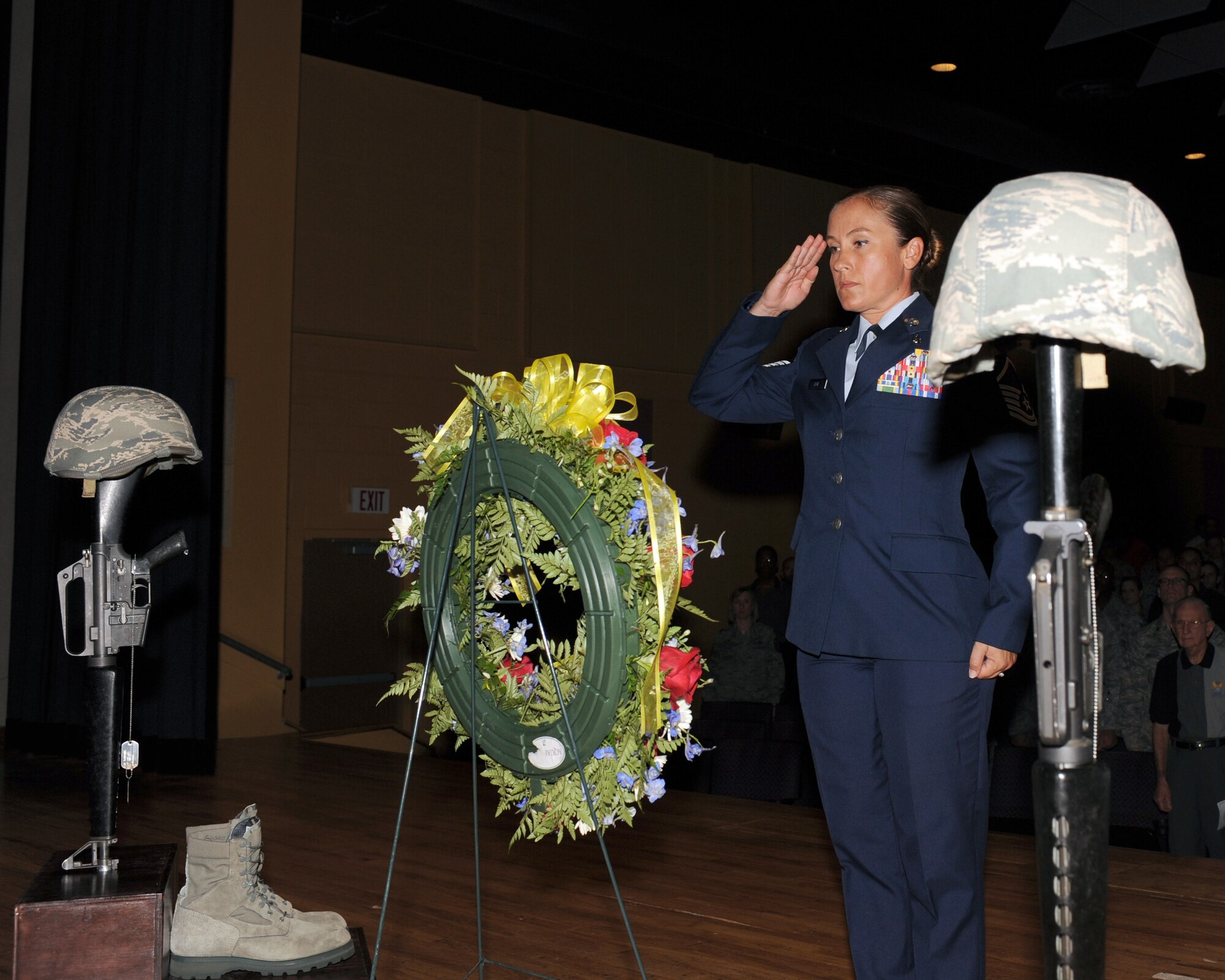 U.S. Air Force Master Sgt. Angela Blue, 355th Medical Operations Squadron, salutes the wreath during the 9/11 Remembrance ceremony on Davis-Monthan Air Force Base, Ariz., Sept 11, 2012. D-M honored those who were lost, as well as those who served during, continued to serve, and chose to serve after 9/11. (U.S. Air Force photo by Airman 1st Class Timothy Moore/Released)