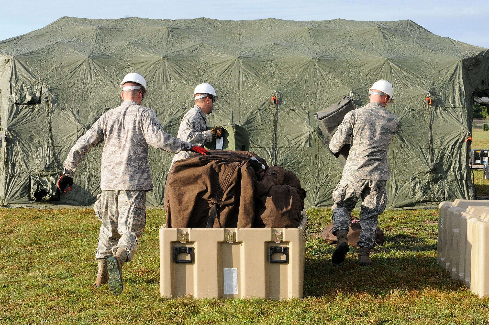 Members of the 267th Combat Communications Squadron (267 CBCS) assemble a Deployable Rapid Assembly Shelter (DRASH) during an Operational Readiness Inspection (ORI) at Otis Air National Guard Base, Mass., Sept. 10. The portable shelter is used for the buildup of a simulated deployed communications site. The primary mission of the 267 CBCS is to deploy, operate, and maintain strategic dispersal of emergency communications anywhere in the world. (Air National Guard photo by Tech. Sgt. Kerri Cole/Released)