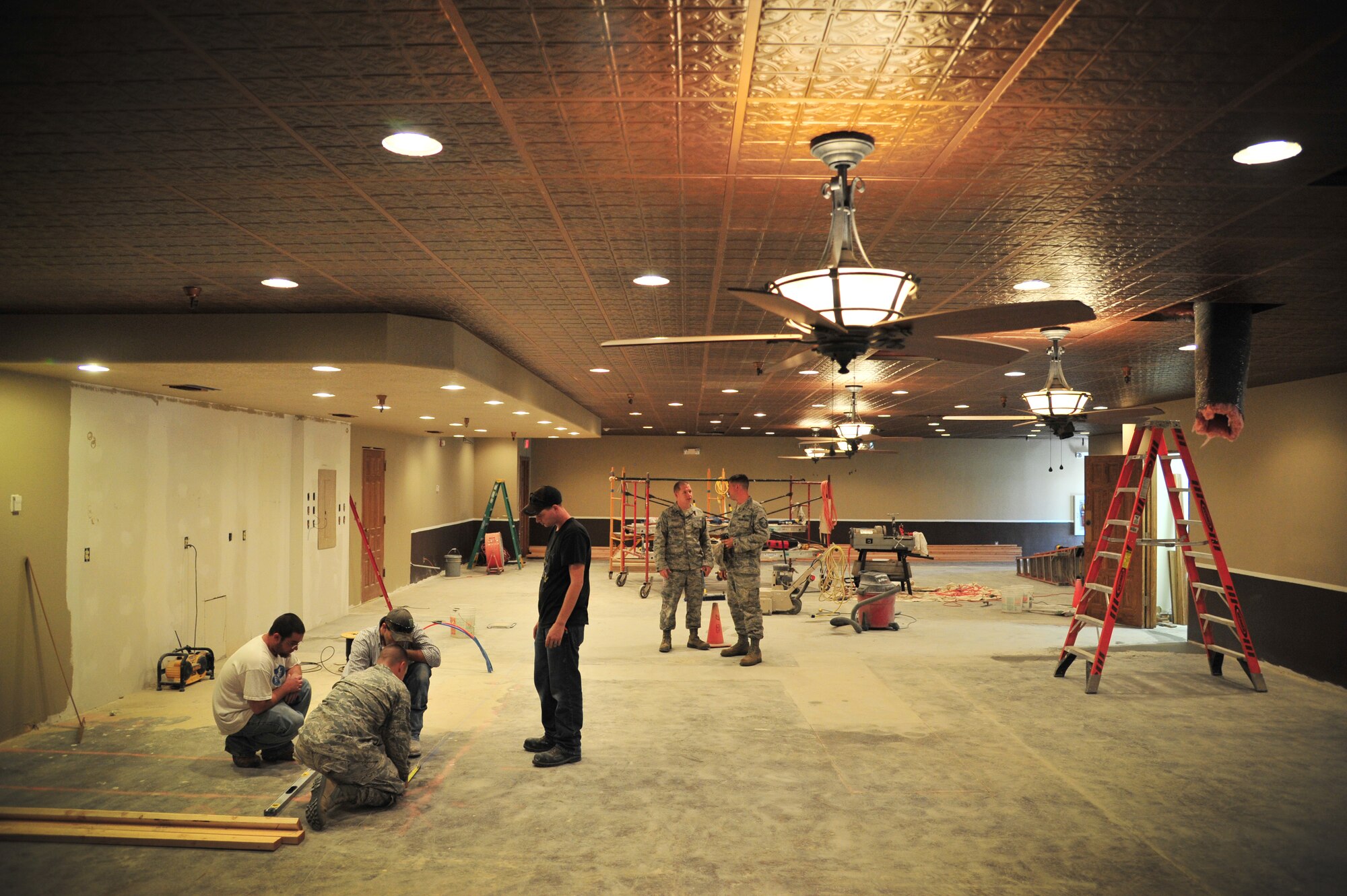 Members of the 27th Special Operations Civil Engineer Squadron Specialized Maintenance Team work on multiple projects for the reconstruction in the Tumbleweed Lounge in The Landing Zone at Cannon Air Force Base, N.M., Sept. 7, 2012. Air Commandos with the SMT are saving the wing countless dollars by taking on full renovations of the lounge as part of an in-house job. (U.S. Air Force photo/Airman 1st Class Alexxis Pons Abascal)  