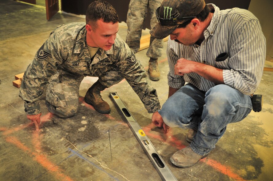U.S. Air Force Tech. Sgt. Shaun Lyle, 27th Special Operations Civil Engineer Squadron Specialized Maintenance Team member, plots out positioning with another SMT member for the reconstruction of the Tumbleweed Lounge in The Landing Zone at Cannon Air Force Base, N.M., Sept. 7, 2012. Air Commandos with the SMT are saving the wing countless dollars by taking on full renovations of the lounge as part of an in-house job. (U.S. Air Force photo/Airman 1st Class Alexxis Pons Abascal)  