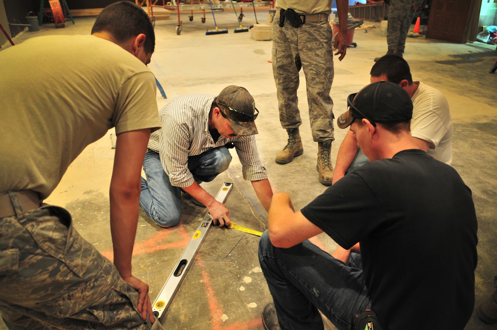 Members of the 27th Special Operations Civil Engineer Squadron Specialized Maintenance Team take measurements and layout floor plans for reconstruction in the Tumbleweed Lounge in The Landing Zone at Cannon Air Force Base, N.M., Sept. 7, 2012. Air Commandos with the SMT are saving the wing countless dollars by taking on full renovations of the lounge as part of an in-house job. (U.S. Air Force photo/Airman 1st Class Alexxis Pons Abascal)  