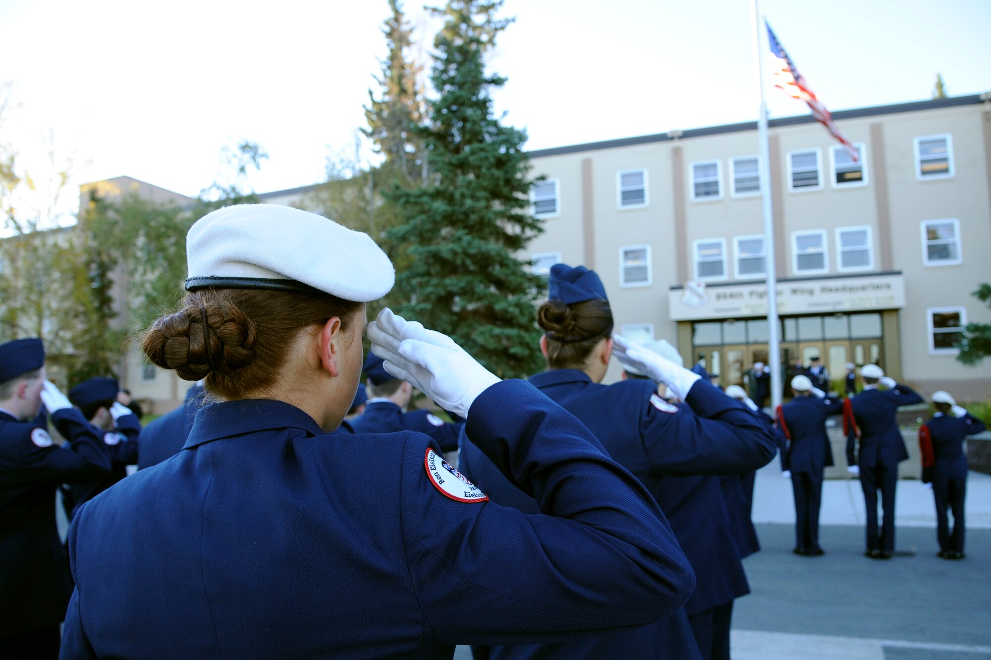 Cadets from Ben Eielson High School Air Force Junior ROTC render salutes to the American flag in honor of Patriot Day at Amber Hall Sept. 11, 2012, Eielson Air Force Base, Alaska. Patriot Day is a day our nation remembers those who lost their lives and loved ones on 9/11. (U.S. Air Force photo/Staff Sgt. Jim Araos)