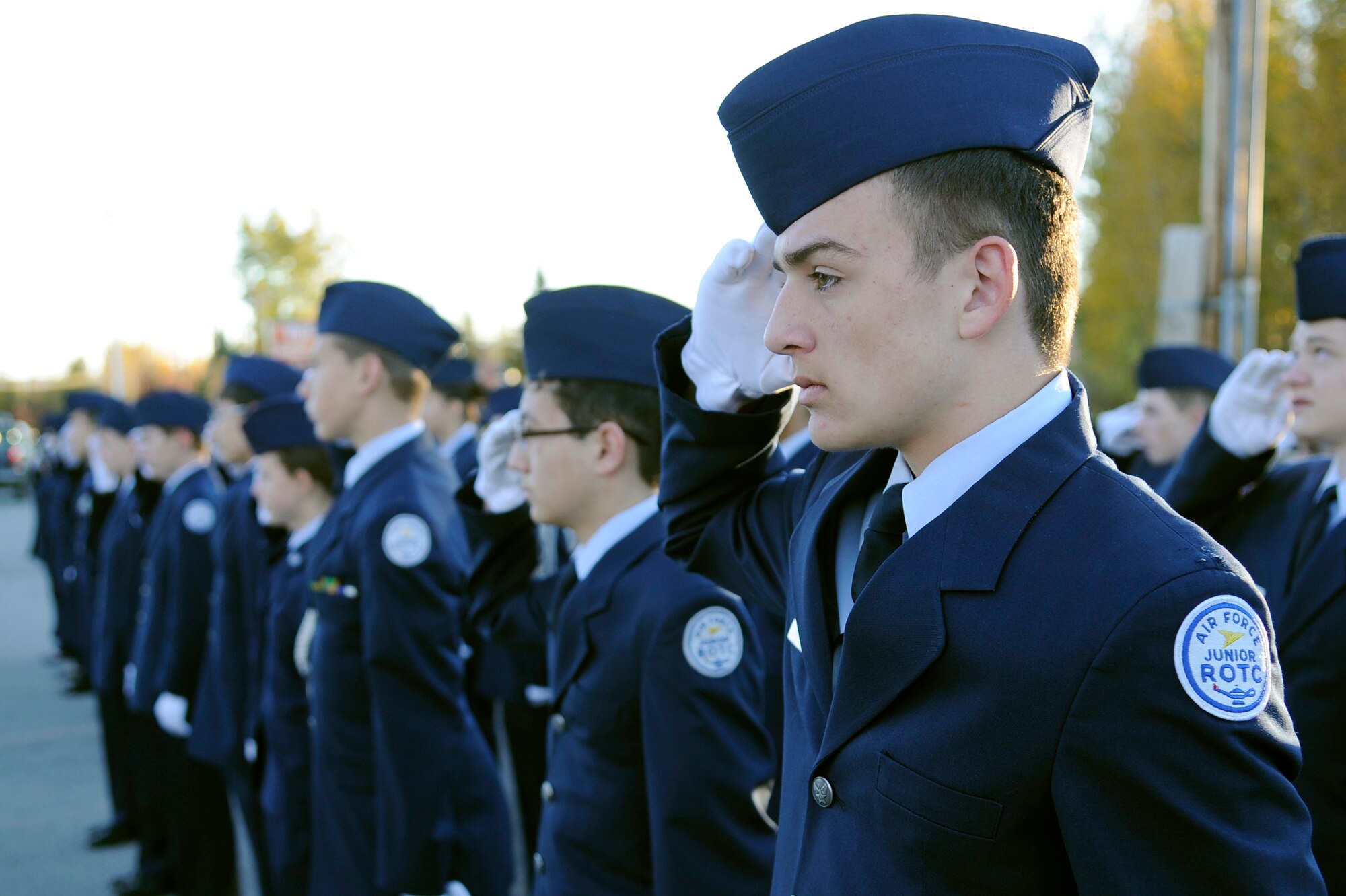 Cadets from Ben Eielson High School Air Force Junior ROTC render salutes to the American flag in honor of Patriot Day at the Ben Eielson Junior-Senior High School Sept. 11, 2012, Eielson Air Force Base, Alaska. Cadets learn proper customs and courtesies as part of their training program so they may perform ceremonies correctly. (U.S. Air Force Photo/Staff Sgt. Jim Araos)