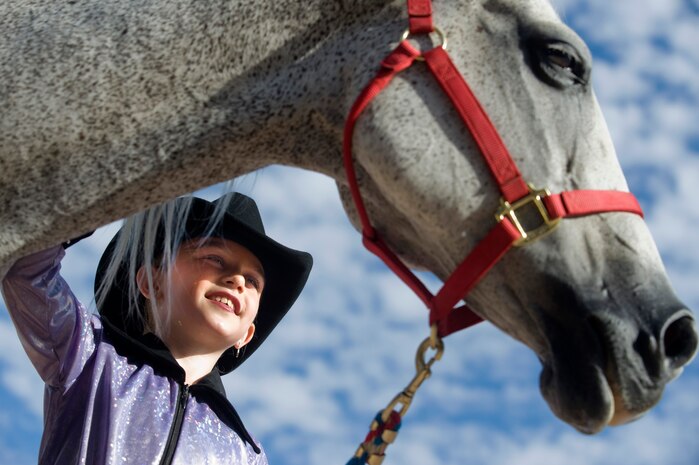 Chloe Kenny, daughter of Brian Kenny, pets her horse before competing in the 4th annual Red, White and Blue Jeans Walk-Trot run by the Horses 4Heroes organization Sept. 8, 2012, at Horseman's Park, Las Vegas, Nev. Horses4Heroes provides interactions with horses and farm animals that empower, engage and inspire military children and their families. U.S. Air Force photo by Senior Airman Daniel Hughes) 
