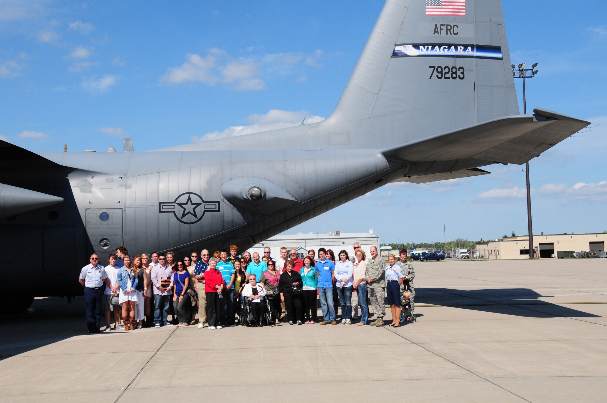 The 107th Airlift Wing remembers 9/11 by enlisting new airmen into the unit. Seven new members join the Air National Guard on Sept. 11, 2012. Family members of the new airman pose with the C-130 aircraft at the Niagara Falls Reserve Station. (U. S. Air Force Photo/Senior Master Sgt. Ray Lloyd)