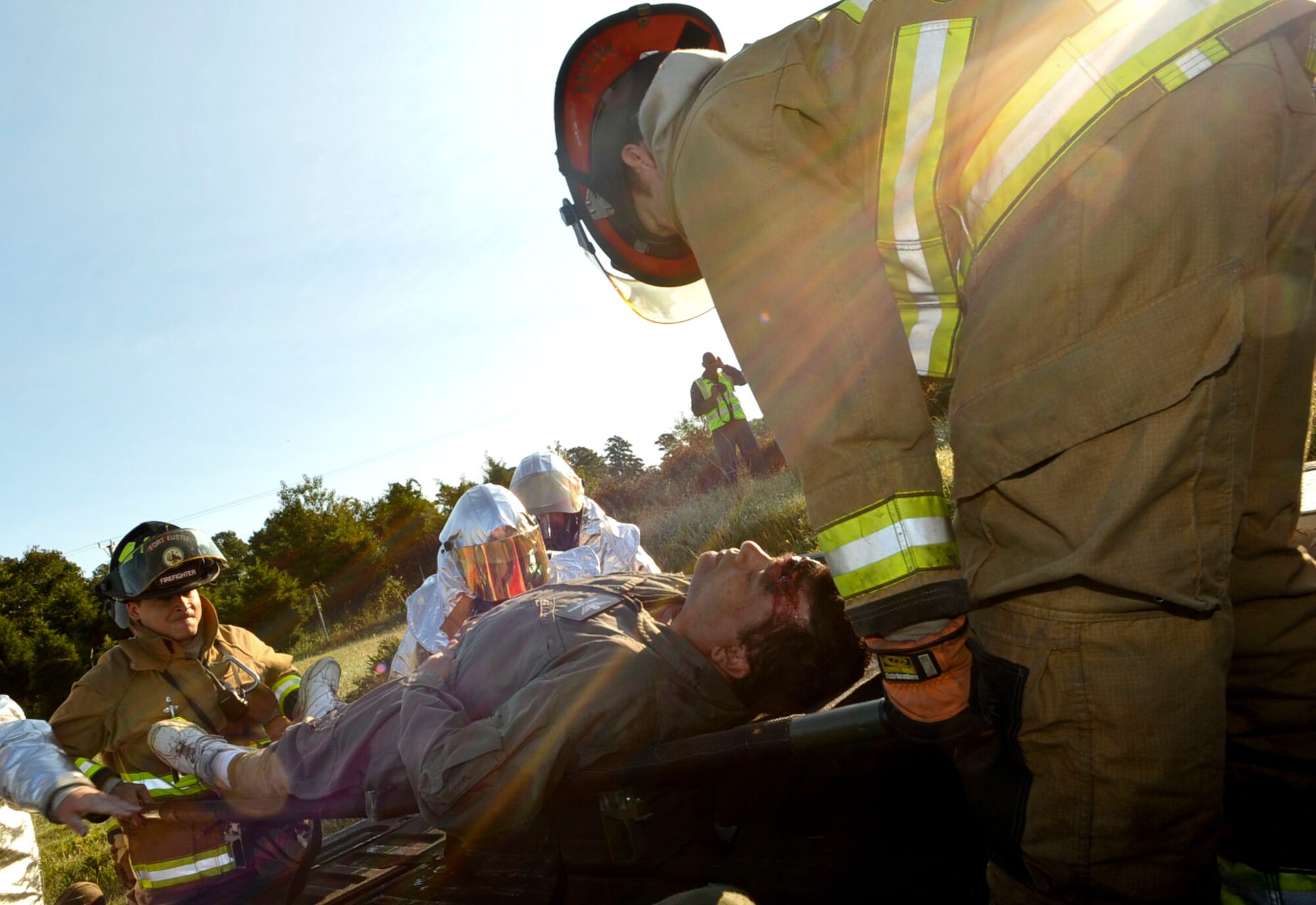 Firefighters with the 733rd Civil Engineer Division fire department load a crash victim into the back of a truck to transport him to waiting medical personnel during a major accident response exercise at Fort Eustis, Va., Sept. 12, 2012. The exercise scenario began with an U.S. Navy UH-60 Blackhawk helicopter crashing at the slope area at Felker Army Airfield with four crew members on board. (U.S. Air Force photo by Staff Sgt. Wesley Farnsworth/Released)