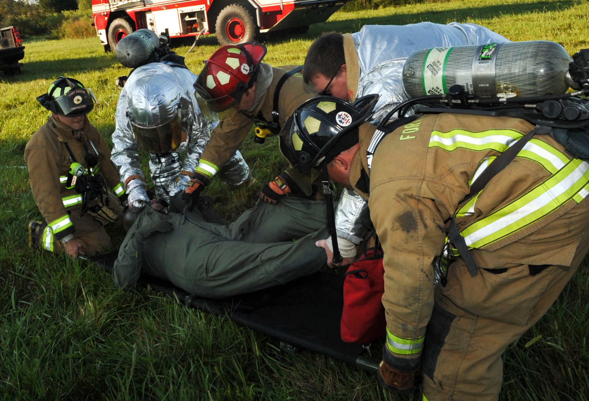 Firefighters with the 733rd Civil Engineer Division fire department load a crash victim onto a stretcher for transport to waiting medical personnel during a major accident response exercise at Fort Eustis, Va., Sept. 12, 2012. The MARE was the first rotary-wing crash exercise performed by the 633rd Air Base Wing at Fort Eustis since becoming a joint base in 2010. (U.S. Air Force photo by Staff Sgt. Wesley Farnsworth / Released)