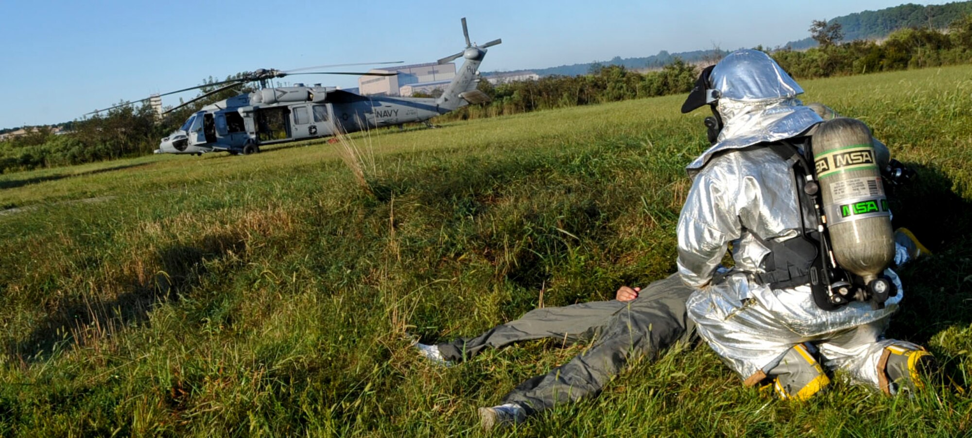 A Firefighter with the 733rd Civil Engineer Division fire department locates and checks on a victim that had been thrown from a simulated-downed U.S. NAVY UH-60 Blackhawk helicopter during its landing as part of a major accident response exercise at Fort Eustis, Va., Sept. 12, 2012. Approximately 50 personnel, including emergency responders, command and control representatives, and U.S. Navy safety personnel participated in the MARE. (U.S. Air Force photo by Staff Sgt. Wesley Farnsworth / Released) 