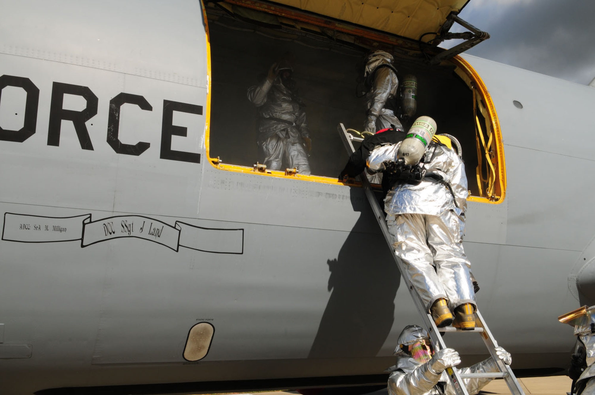 RAF MILDENHALL, England – Firefighters from the 100th Civil Engineer Squadron Fire Department open up the cargo door on a KC-135 Stratotanker parked on a hardstand at the RAF Mildenhall flightline during an exercise Sept. 11, 2012,. They responded to a simulated fire as a result of mock attack during an operational readiness exercise. (U.S. Air Force photo/Karen Abeyasekere)