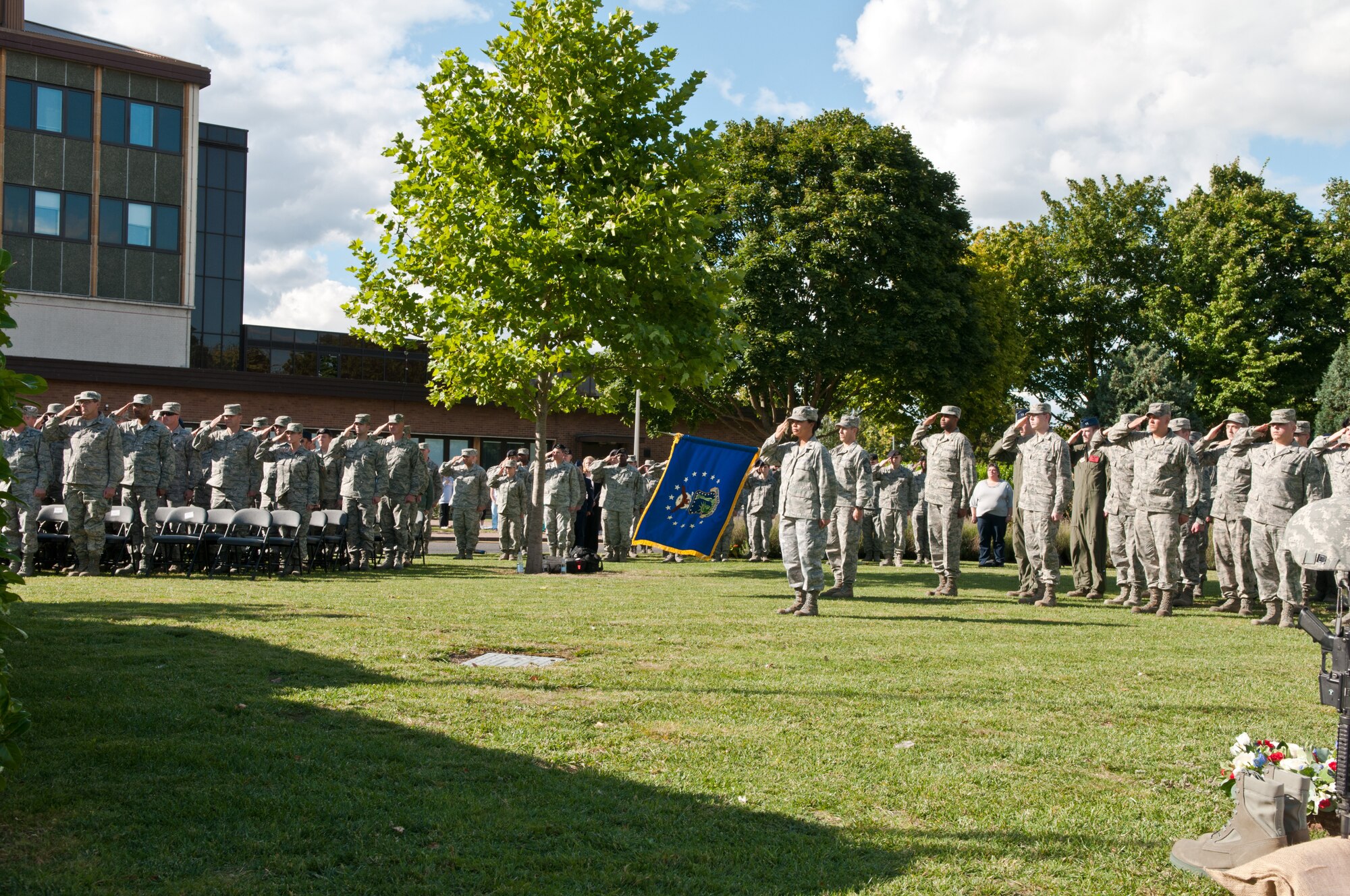 ROYAL AIR FORCE LAKENHEATH, England - Airmen from the 48th Fighter Wing salute during the playing of the U.S. and U.K. national anthems at the 9/11 Remembrance Ceremony Sept. 11, 2012. The ceremony honored those lost in the attacks on Sept. 11, 2001. (U.S. Air Force photo by Senior Airman Connor Estes)