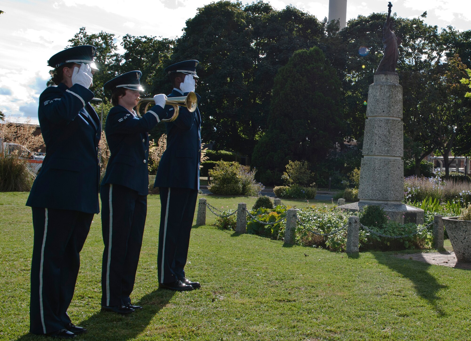 ROYAL AIR FORCE LAKENHEATH, England - Airman 1st Class Lea Gleason, 48th Civil Engineer Squadron, emergency management journeyman, plays taps on a bugle during retreat at the 9/11 Remembrance Ceremony, Sept. 11, 2012. The ceremony honored those lost in the attacks on Sept. 11, 2001. (U.S. Air Force photo by Senior Airman Connor Estes)