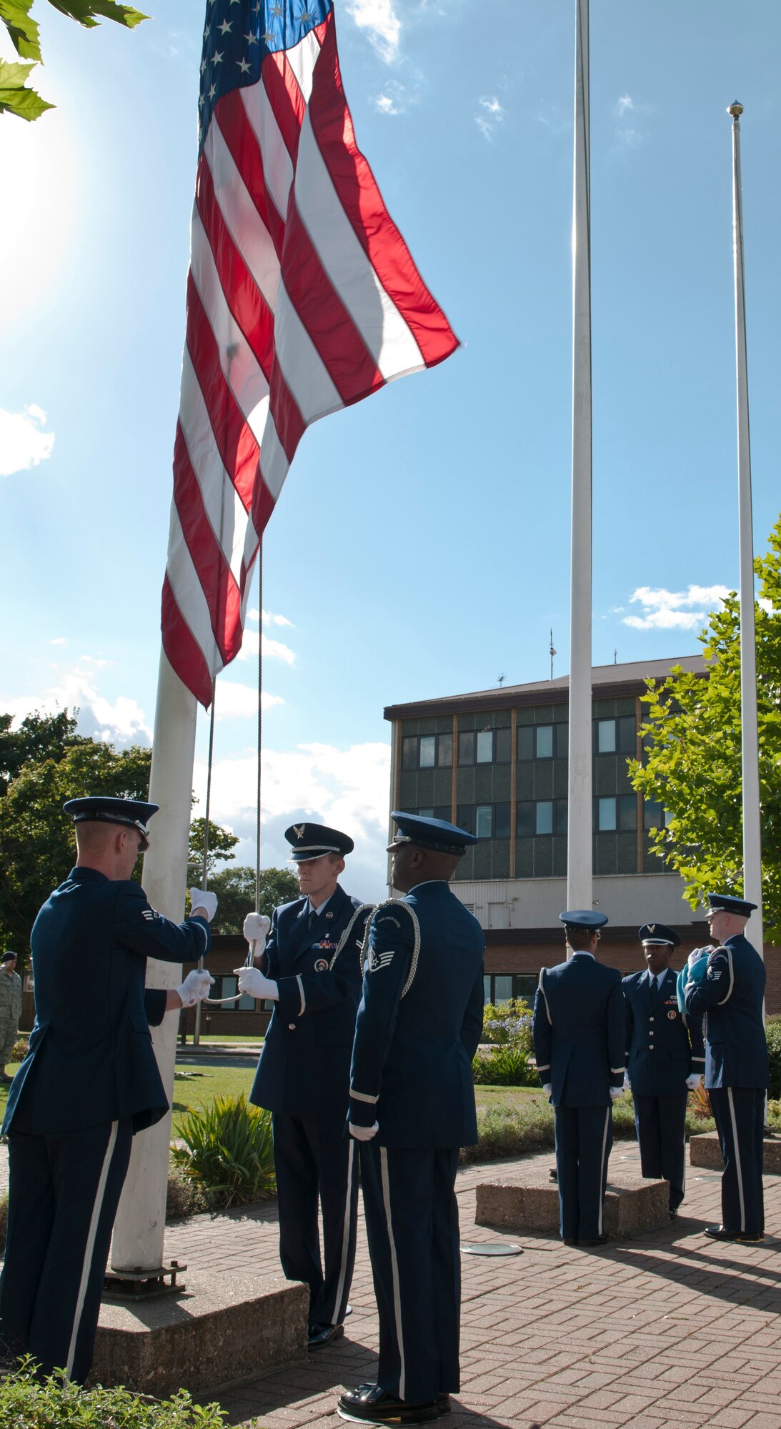ROYAL AIR FORCE LAKENHEATH, England - Honor Guard team from the 48th Fighter Wing lower the U.S. and U.K. flags during retreat at the 9/11 Remembrance Ceremony Sept. 11, 2012. The ceremony honored those lost in the attacks on Sept. 11, 2001. (U.S. Air Force photo by Senior Airman Connor Estes)