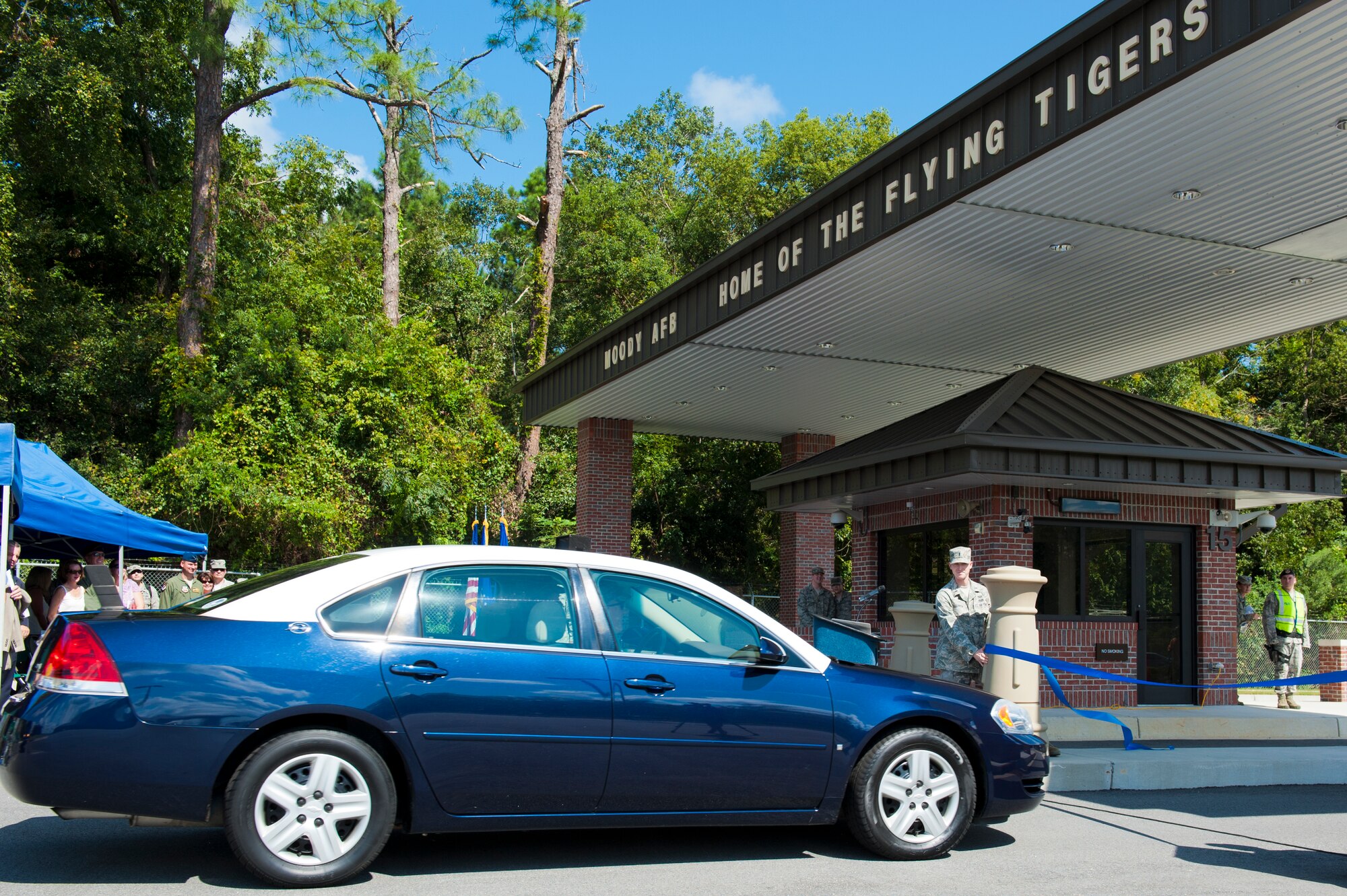 U.S. Air Force Col. Billy Thompson, 23d Wing commander, drives the inaugural vehicle through a ribbon during the Davidson Road gate ribbon cutting ceremony at Moody Air Force Base, Ga., Sept. 7, 2012. The Davidson Road gate will ease the flow of local community traffic, by moving the gate off the main road. (U.S. Air Force photo by Staff Sgt. Joshua J. Garcia/Released)