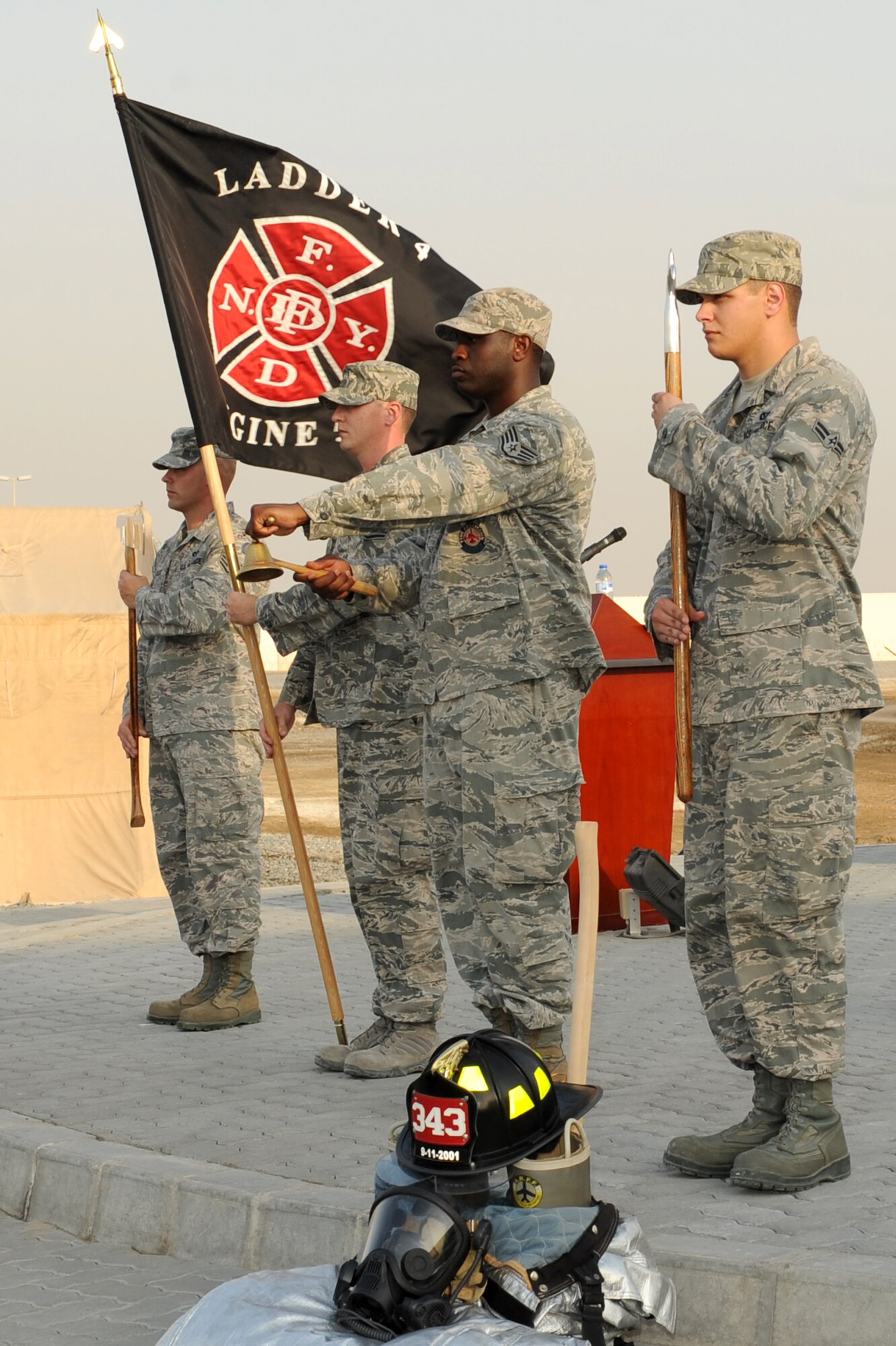 SOUTHWEST ASIA - U.S. Air Force Staff Sgt. Phillip Burns, 380th Expeditionary Civil Engineer Squadron firefighter, rings a bell to commemorate the firefighters who lost their lives on 9/11 during a remembrance ceremony at the 380th Air Expeditionary Wing Sept. 11, 2012. The 380th AEW held a memorial to commemorate the 11th anniversary of this tragic day.  (U.S. Air Force photo/Master Sgt. Scott MacKay)