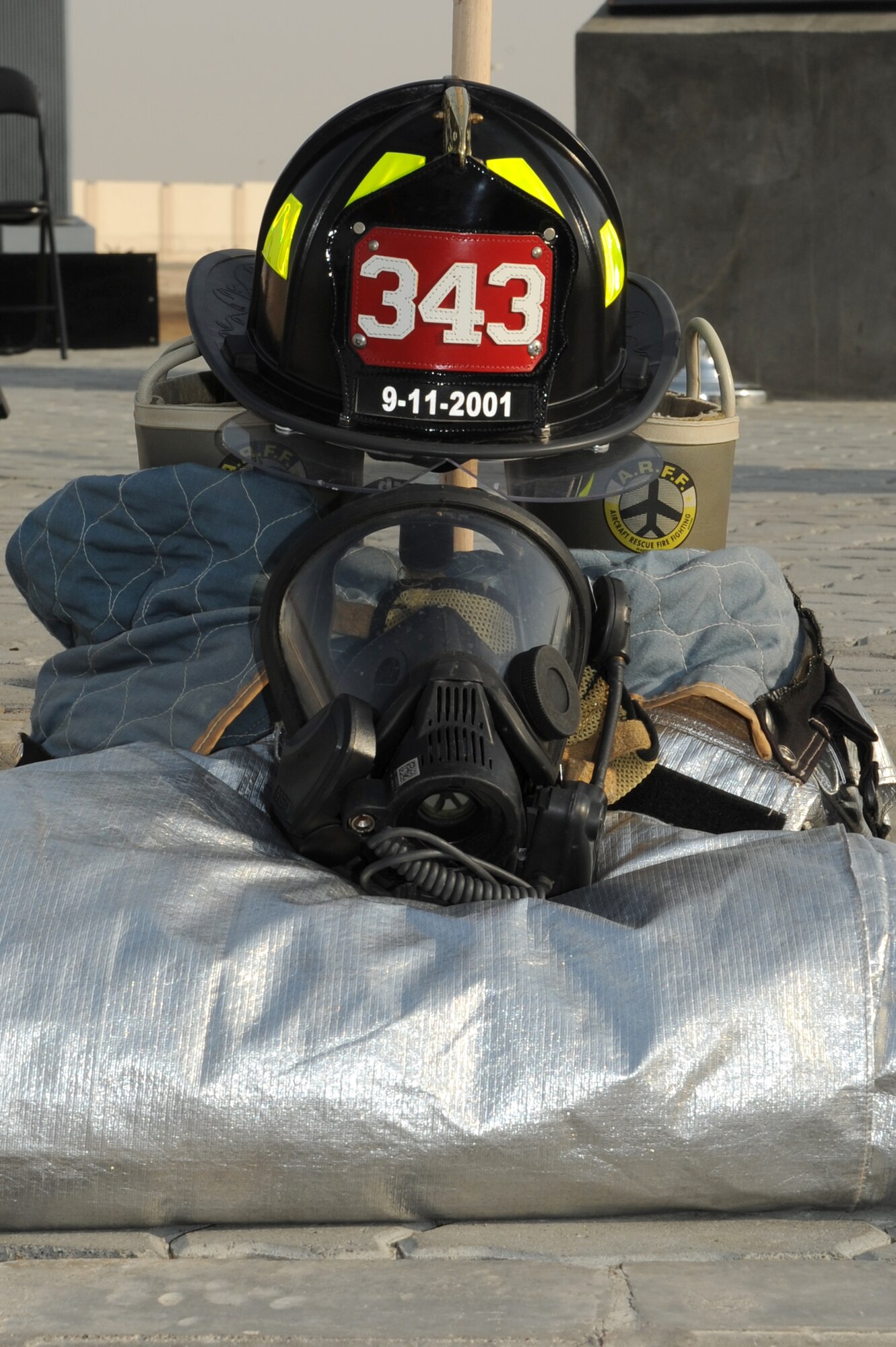 SOUTHWEST ASIA - A firefighter's helmet and mask sits in remembrance of the sacrifices made by first responders during the events of 9/11 Sept. 11, 2012. The 380th Air Expeditionary Wing held a memorial to commemorate the 11th anniversary of this tragic day.  (U.S. Air Force photo/Master Sgt. Scott MacKay)