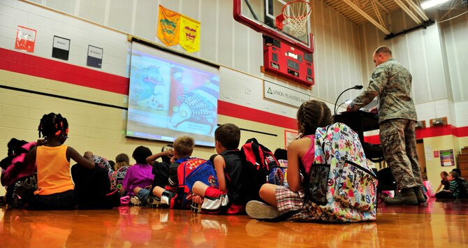 Staff Sgt Brian Darren Kopp, 436 SCOS, reads out loud to kindergarten and first grade students September 6, 2012 in the White side Elementary gym. (U.S. Air Force photo/ Staff Sgt. Stephenie Wade)
