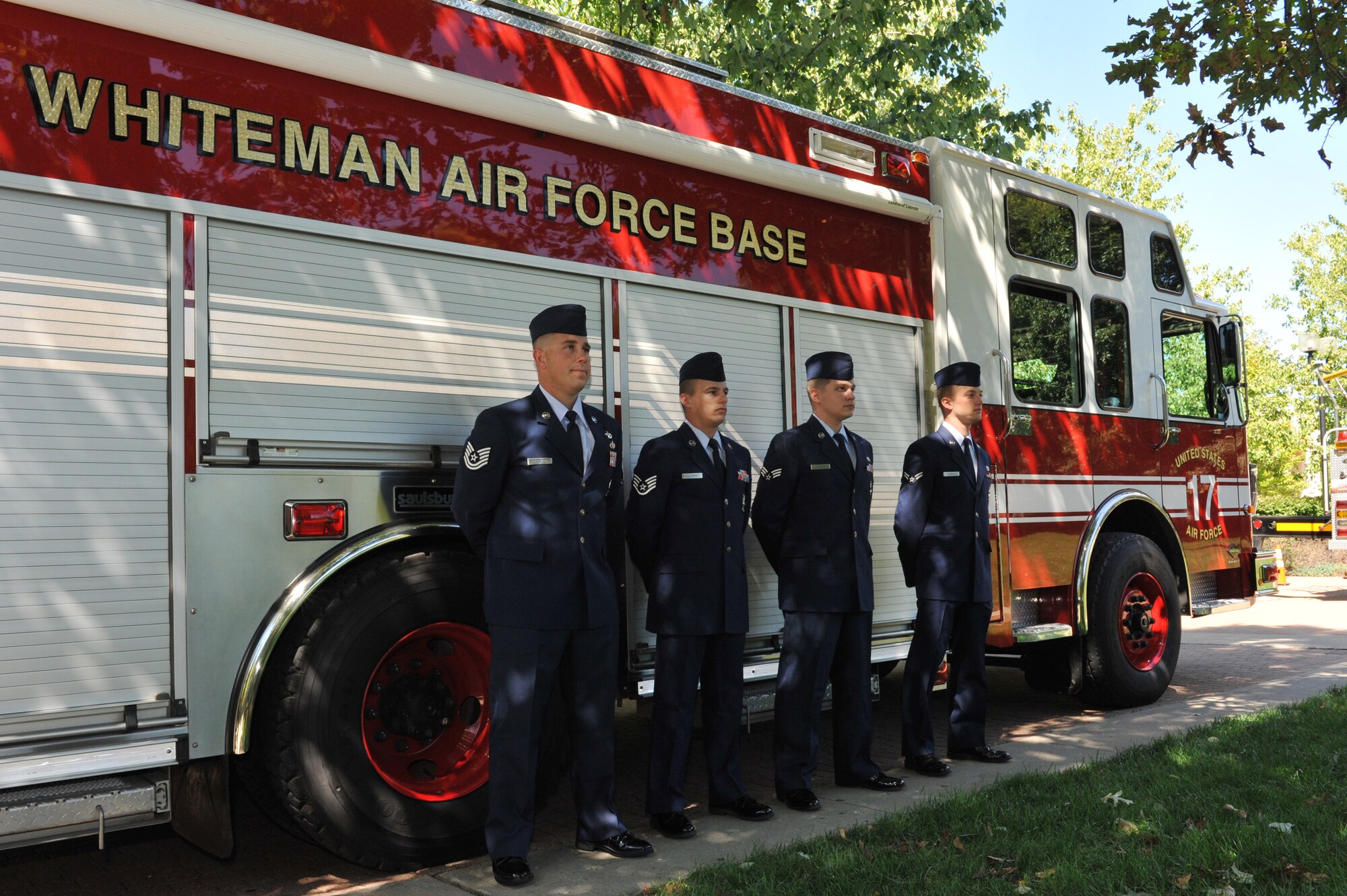 WARRENSBURG, Mo. -- Members of the 509th Civil Engineer Squadron fire department stand at attention prior to a 9/11 Remembrance Ceremony at the University of Central Missouri Sept. 11, 2012. Members of the Collegiate Firefighters Association, local law enforcement and ambulance service personnel from Warrensburg, Johnson County were also in attendance to remember those whose lives were affected by the 9/11 attack. (U.S. Air Force photo/Heidi Hunt) (Released)