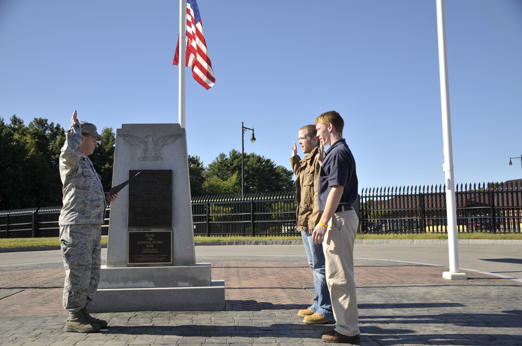 Taylor Gosse (right) and Andrew Jenkerson enlisted into the N.H. Air National Guard by Col. Peter Sullivan outside the 157th Air Refueling Wing headquarters, Pease Air National Guard Base, N.H., September 11, 2012.