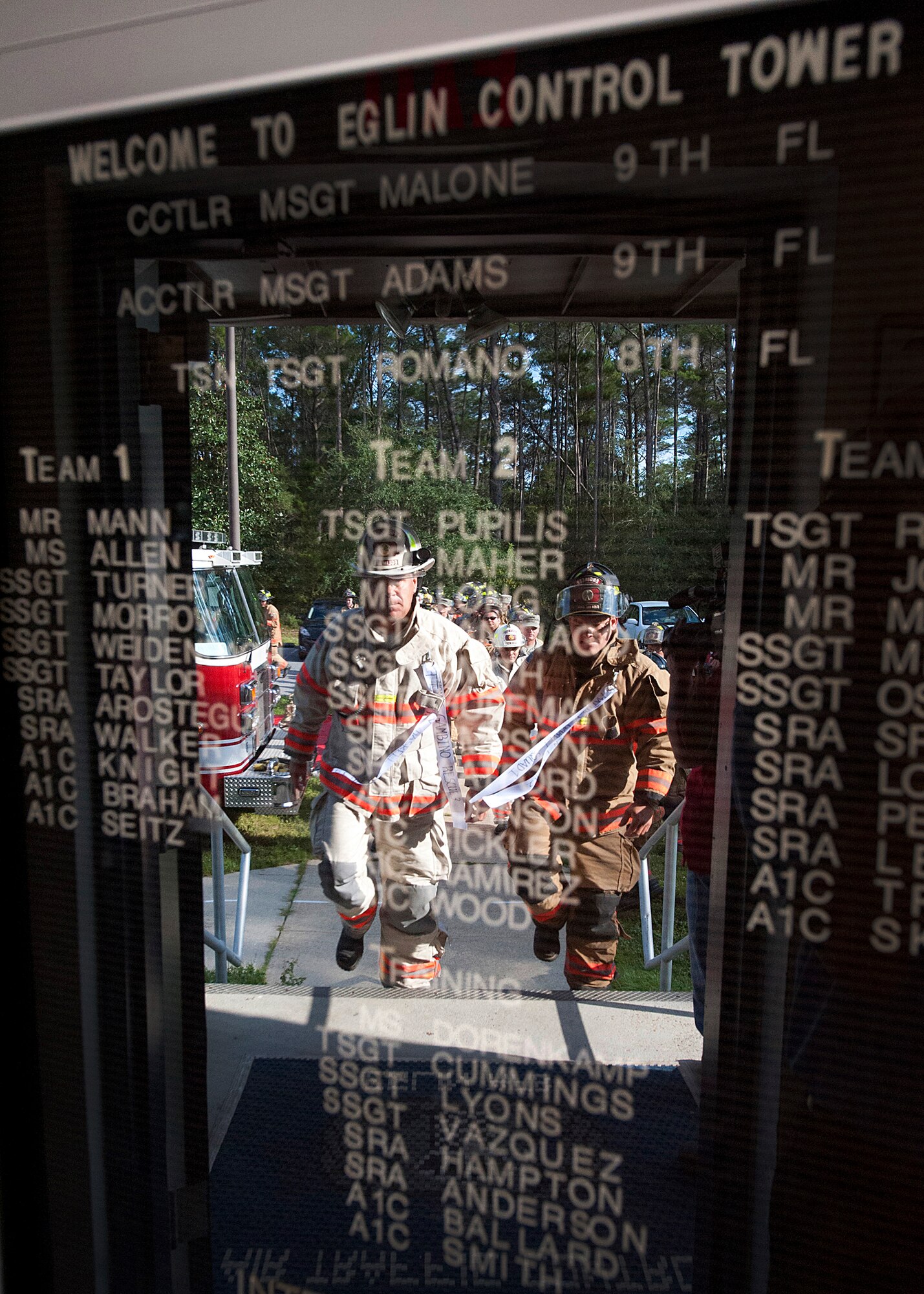 Mark Giuliano, the 96th Test Wing fire chief, moves toward the Eglin's air traffic control tower to begin the climb to the top.  Fire department civilians and service members, ascended the tower in remembrance of the firefighters killed in the World Trade Center terrorist attacks on Sept. 11, 2001. 343 ribbons with the names of their fallen comrades were carried 11 stories to the top of the tower where they were placed over the railing alongside the American Flag.  (U.S. Air Force photo/Randy Gon)