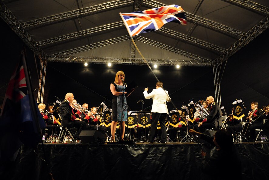 RAF MENWITH HILL, United Kingdom - Laura Jackson sings the British National Anthem with the accompaniment of the Harrogate Band, under the musical direction of Craig Ratcliff, during the Menwith Hill Station Proms on the Hill celebration Sept. 7. Each year the MHS community celebrates the proms with music, food and fireworks. (U.S. Air Force photo by Staff Sgt. Debbie Lockhart)
